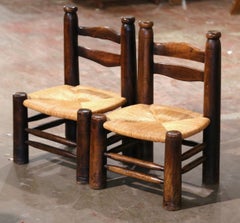 Pair of Early 20th Century French Carved Walnut and Rush Seat Low Chairs