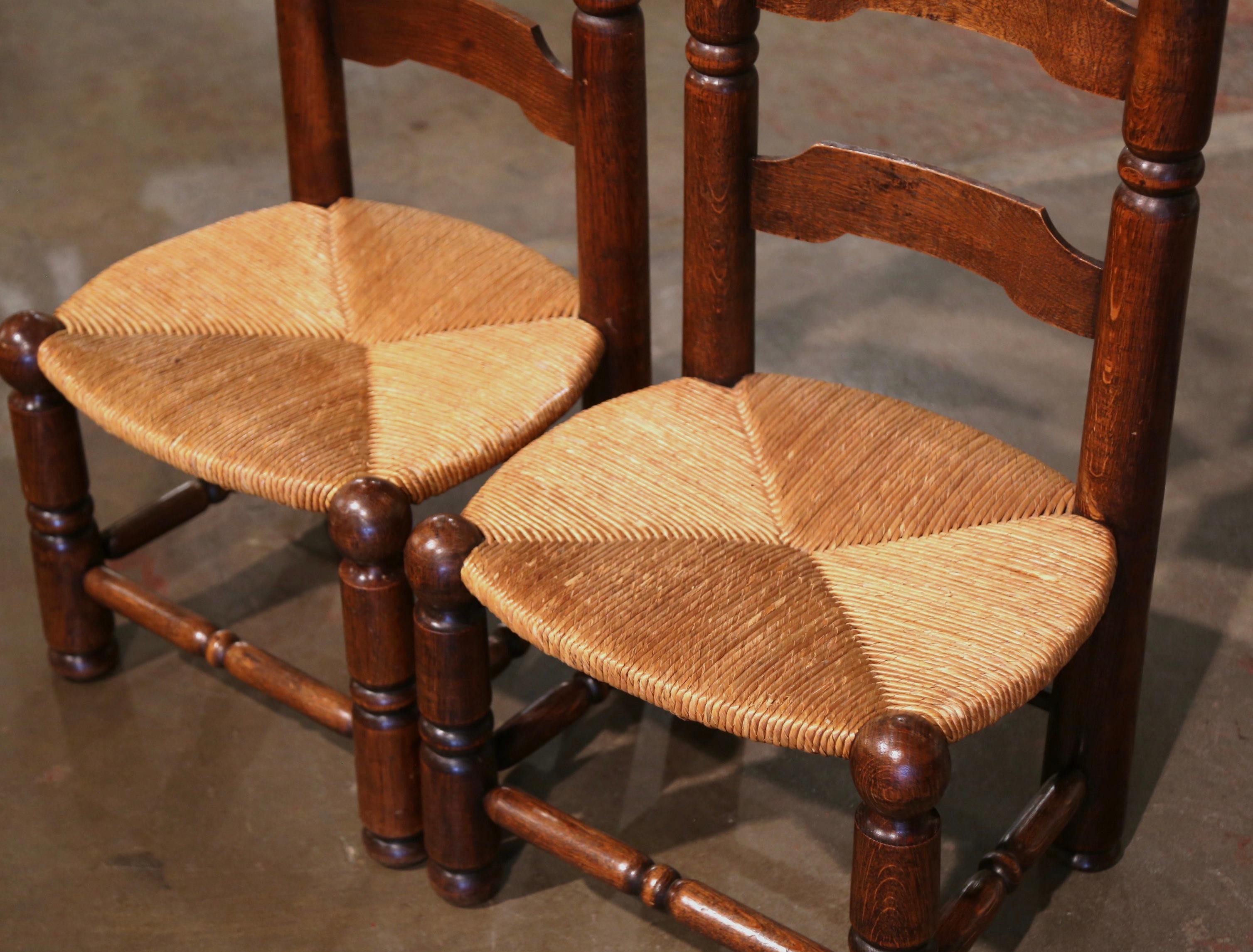 Country Pair of Early 20th Century French Carved Walnut and Rush Seat Low Chairs