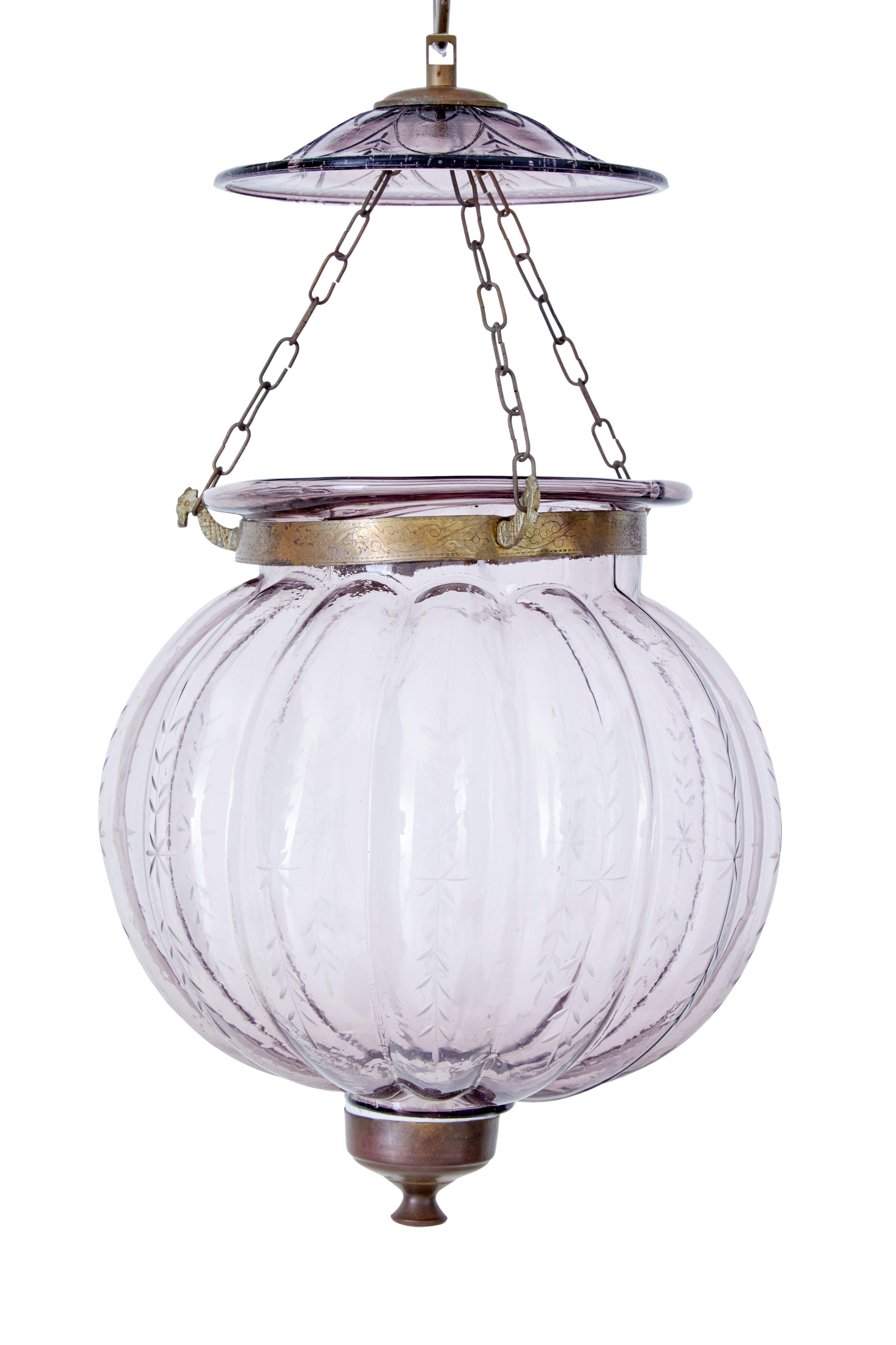 Pair of early 20th century french glass hanging lanterns circa 1920.

Delicate etched pattern along the bulbous organic shaped glass. Linked by 3 chains to the cut glass ceiling mount. Lavender coloured glass.

Ideal for use with a single candle.