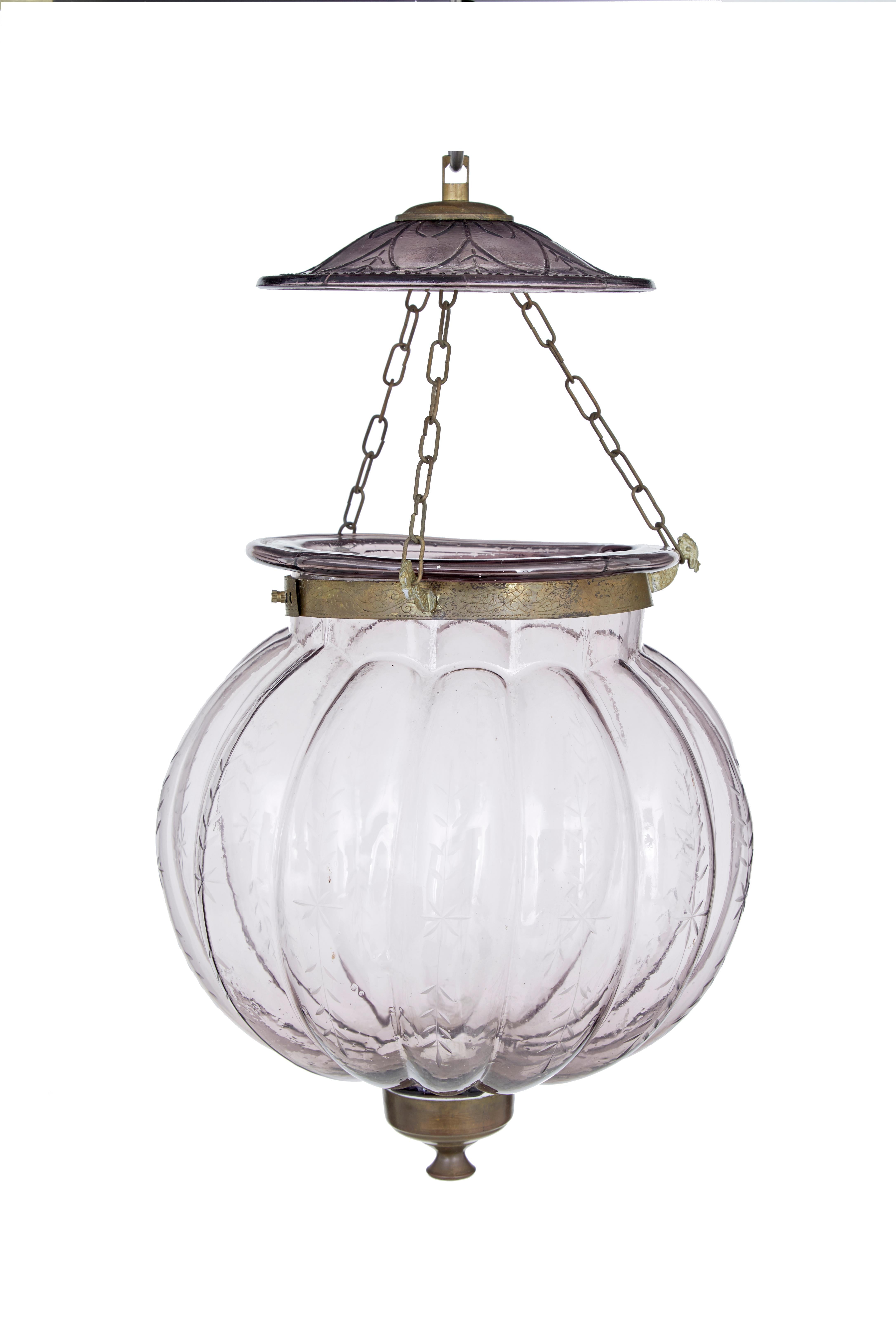 Pair of early 20th century french glass hanging lanterns circa 1920.

Delicate etched pattern along the bulbous organic shaped glass. Linked by 3 chains to the cut glass ceiling mount. Lavender coloured glass.

Restoration to 1 glass lid, which is