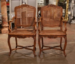 Pair of Early 20th Century French Louis XV Carved Walnut and Cane Armchairs