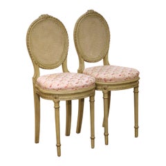 Pair of Early 20th Century French Louis XVI Painted Cane Side Chairs
