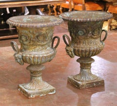 Pair of Early 20th Century French Painted Iron Urns with Figural Mask Handles