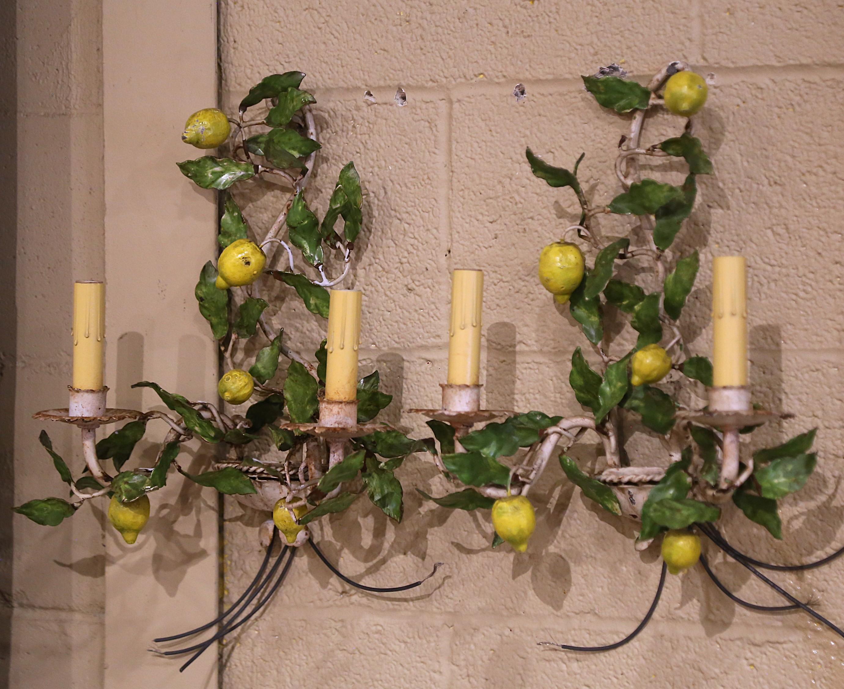 Decorate a powder room with this elegant and feminine antique light fixtures. Crafted in France circa 1920, the petite two-arm sconces are decorated with yellow lemons and embellished with green leaves. The sconces have new wiring dressed with