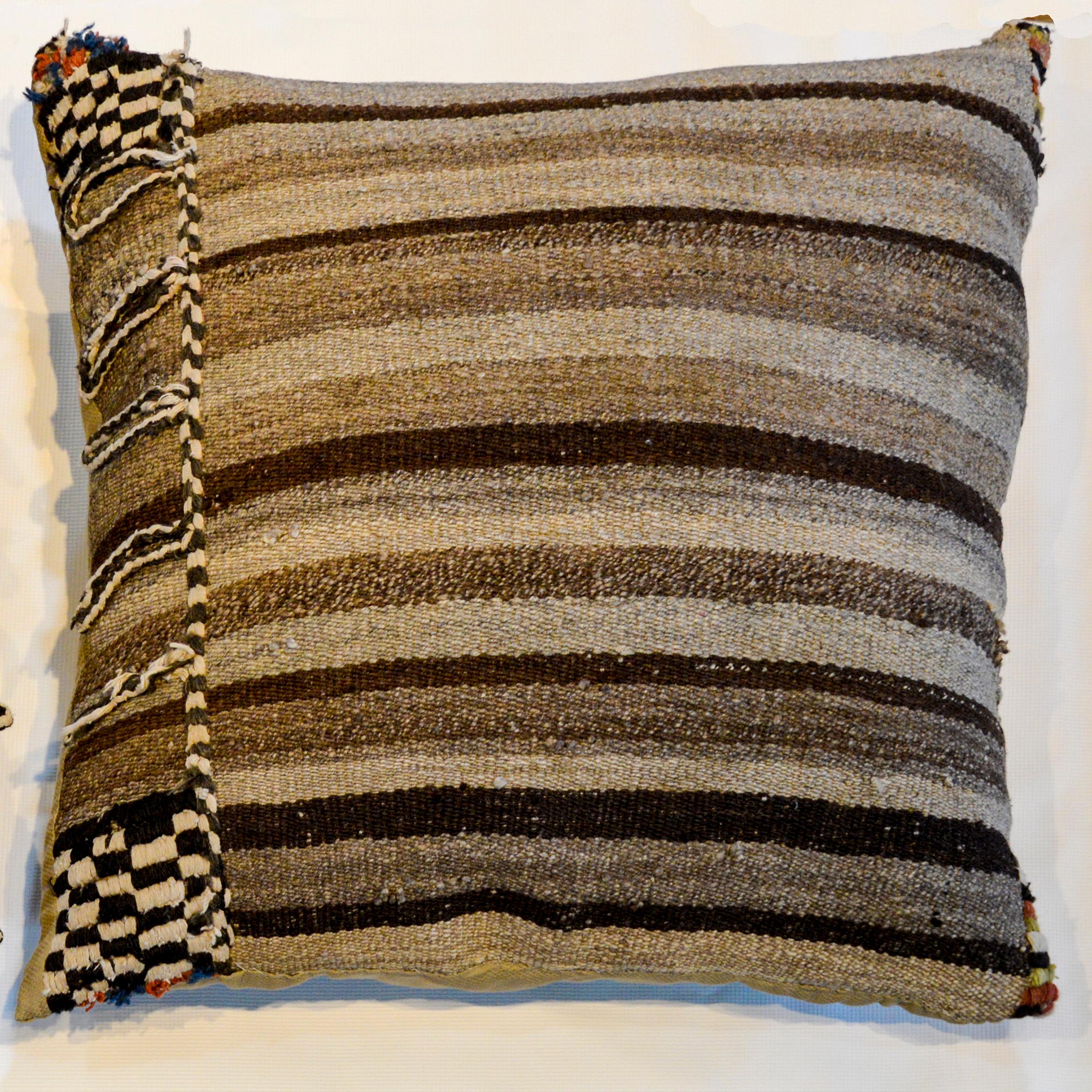 A pair of pillows made from an early 20th century Persian Gabbeh kilim grey and brown stripped saddle bag.