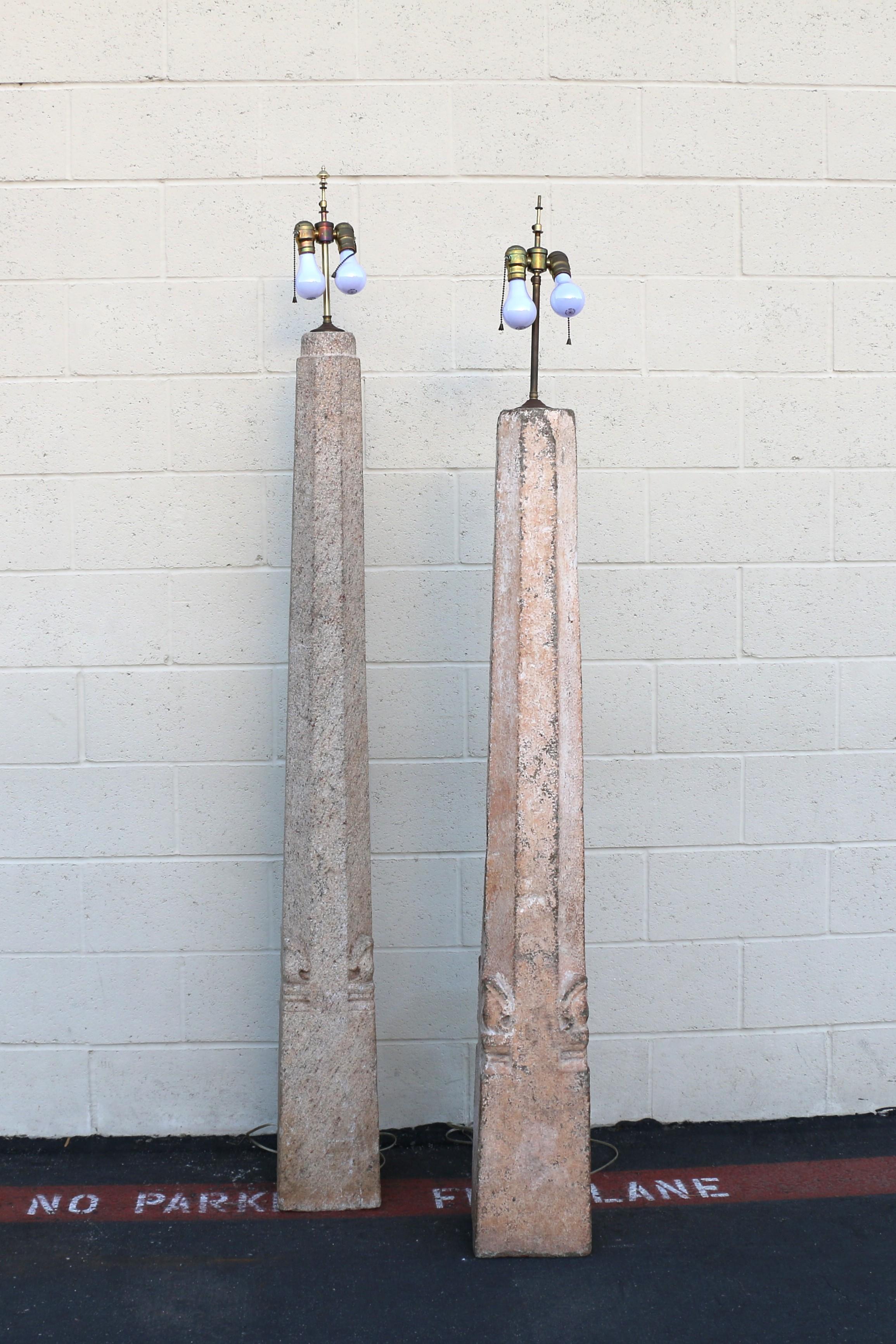 Stunning pair of vintage floor lamps with bases that resemble obelisks or columns. This striking pair of lamps features tall, tapered bases beautifully crafted from solid granite stone, and are designed in a neoclassical or grand tour style. The