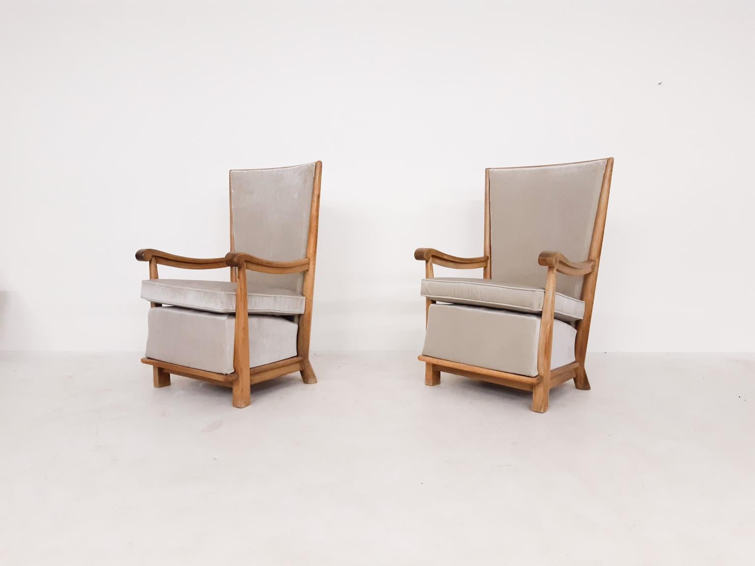 A pair of early 20th century majestic thrones. Made of oak with new velvet upholstery.

We bought these unique chairs from the son of the first owner. His father bought the chairs new for his Dutch mansion somewhere in the first half of the 20th