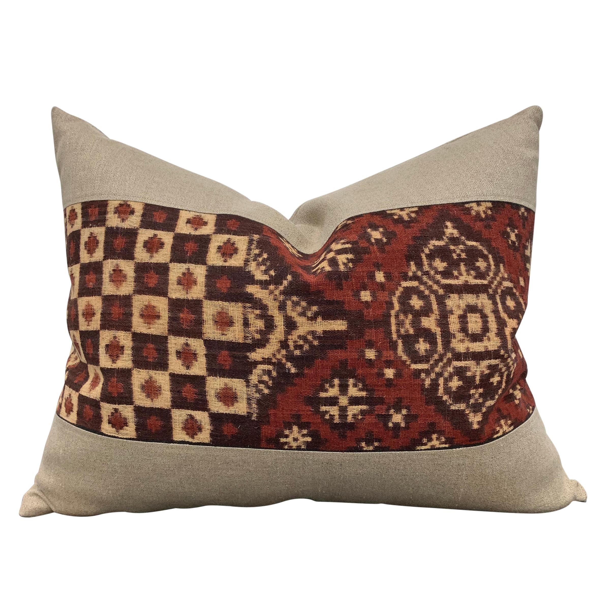 A wonderful pair of pillows made from an early 20th century Indonesian double-ikat panel, backed with linen and filled with down.