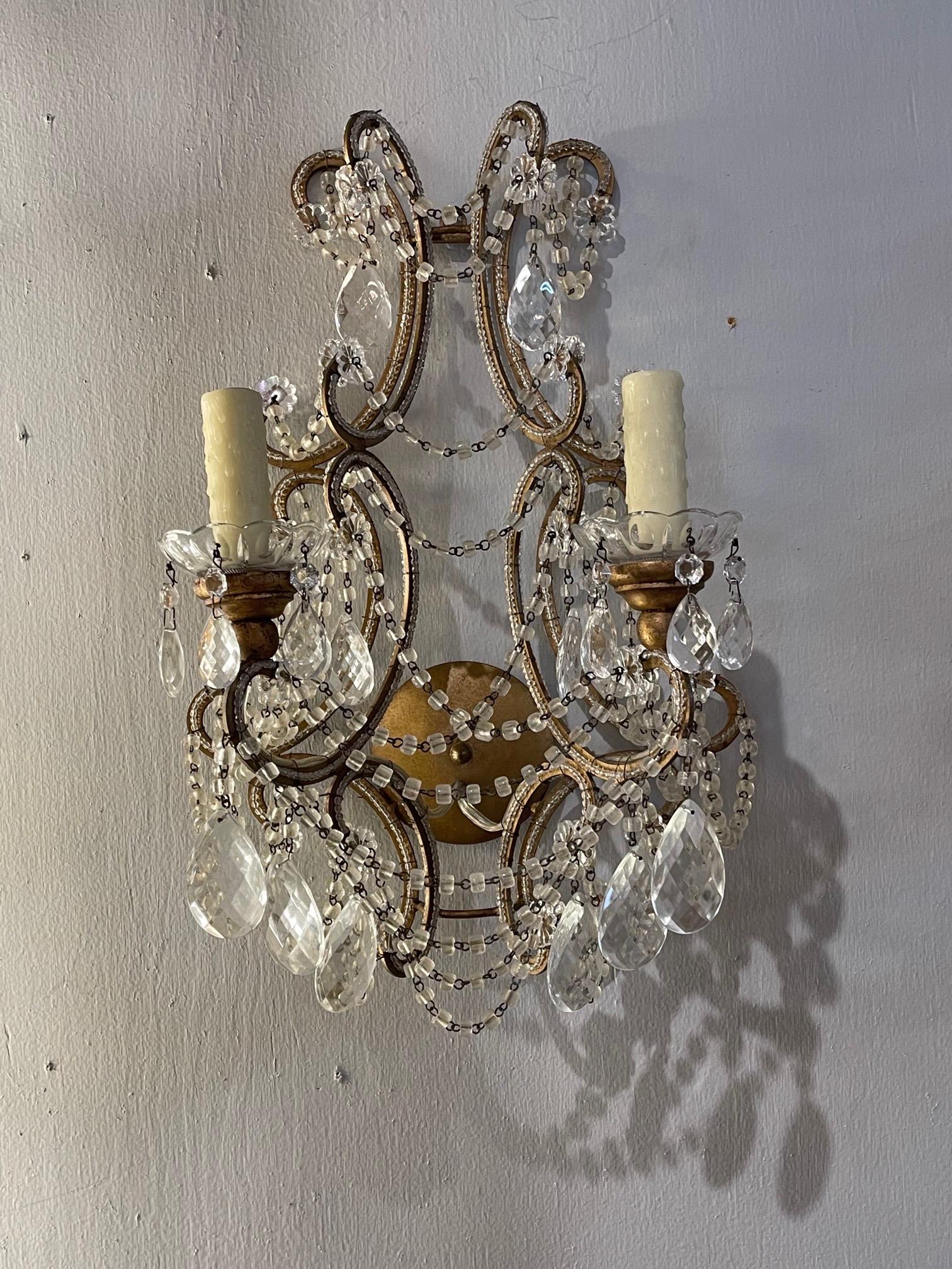 Nice pair of early 20th century Italian beaded 2 light wall sconces. Covered with beautiful crystals on an pretty decorative base. Creates an elegant look!