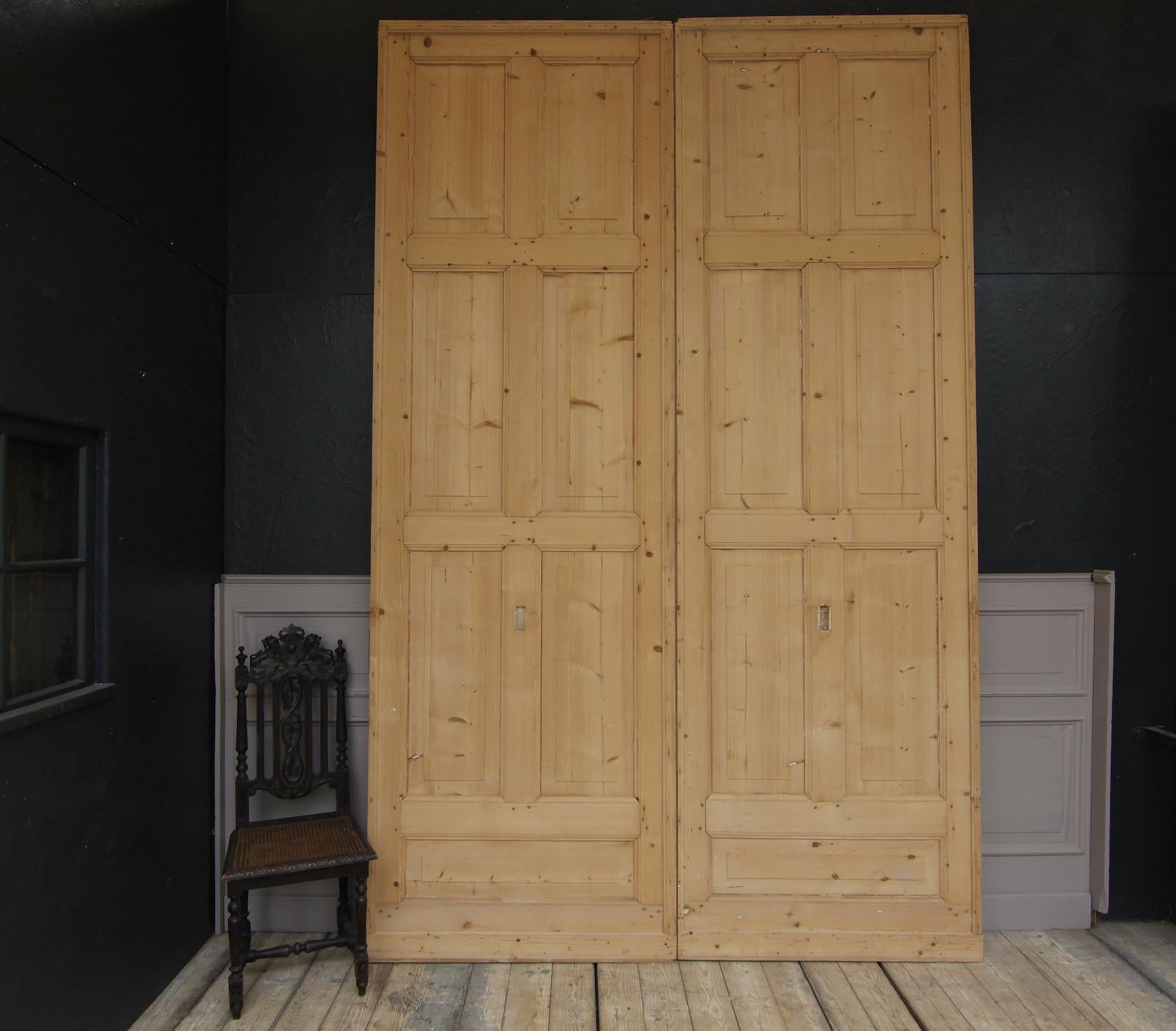 Two large sliding doors from a Swiss villa from around 1900. Made of solid pine wood, each with 7 panels.
The doors are freed from paint in the raw wood state, ready for further processing.

Dimensions per door:
327 cm high / 128.7 inch high,