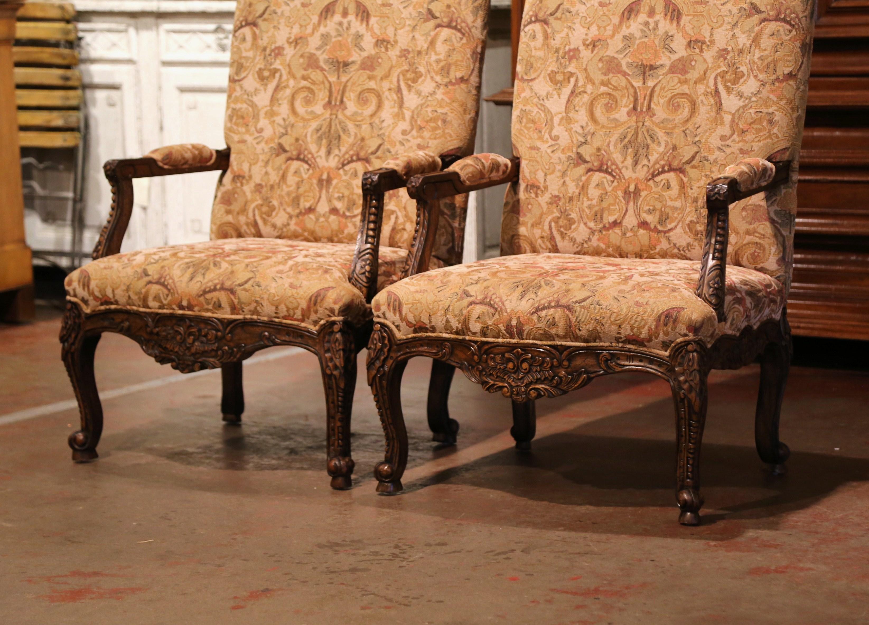 Crafted in Provence, France circa 1920, each comfortable fauteuil stands on cabriole legs decorated with acanthus leaves at the shoulder, and ending with escargot feet. Both armchairs have a tall and arched back, a wide and deep seat with open