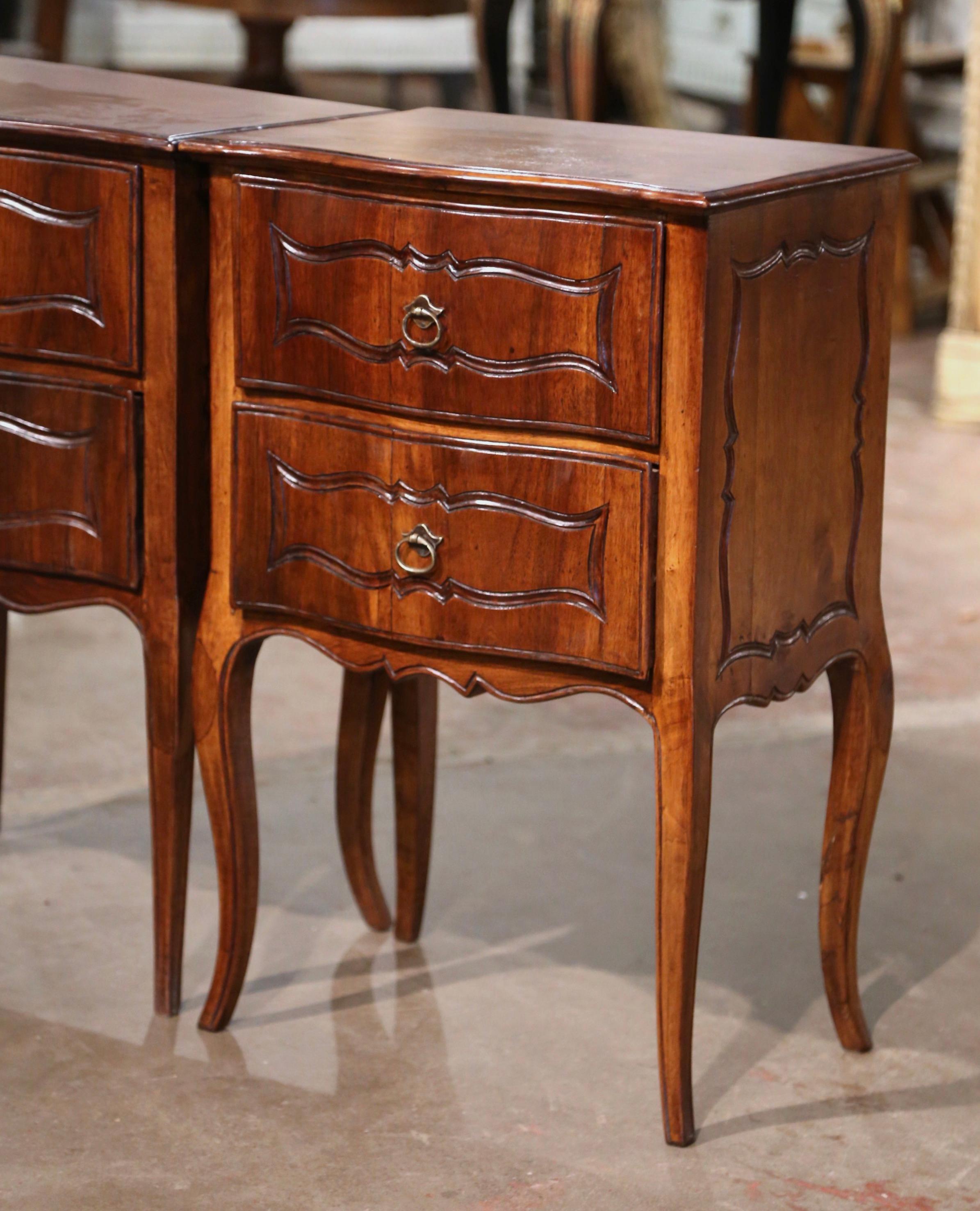 Patinated Pair of Early 20th Century Louis XV Carved Walnut Bombe Two-Drawer Nightstands