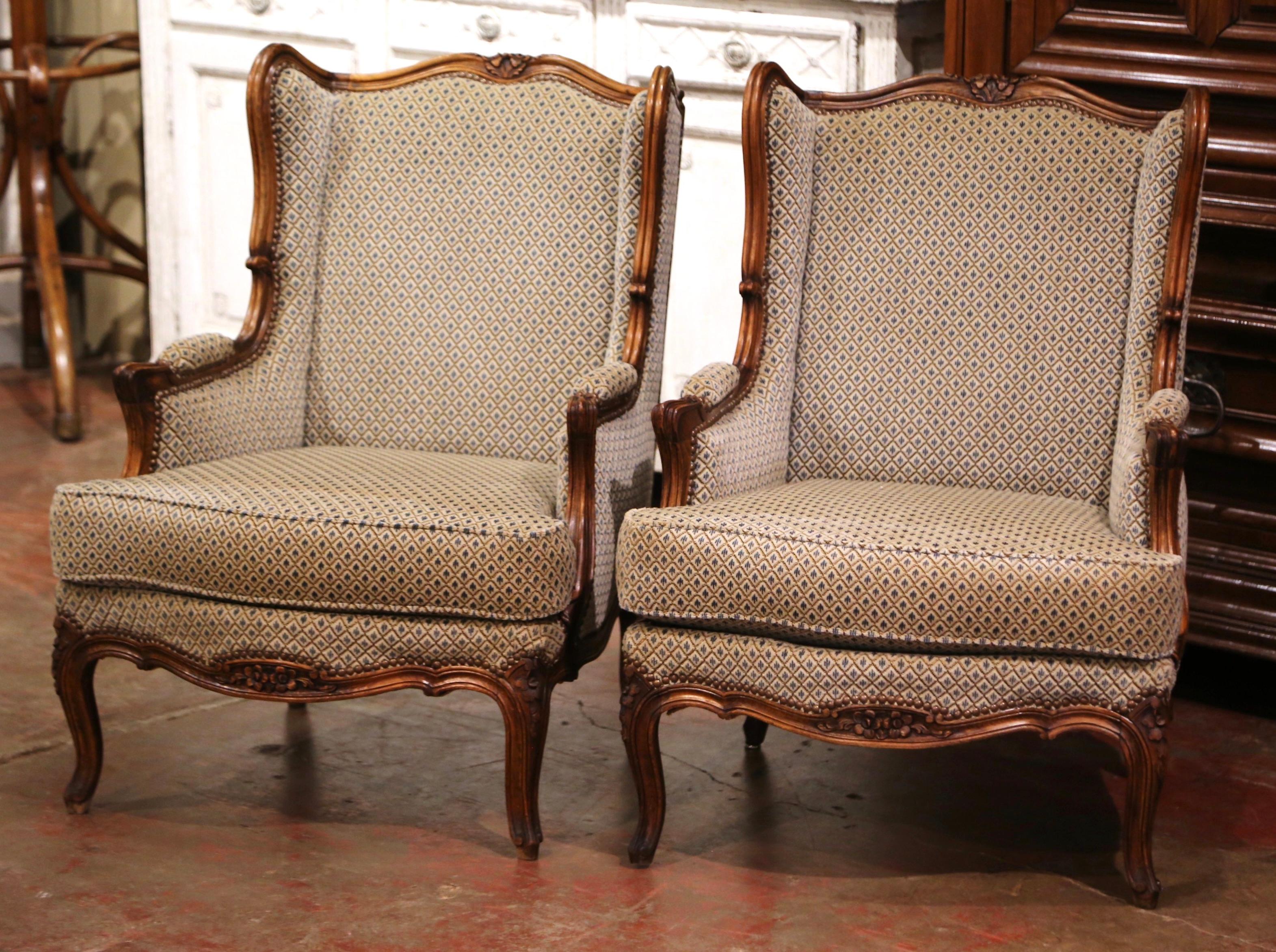 Patinated Pair of Early 20th Century Louis XV Provencal Carved Walnut Wing Back Bergeres