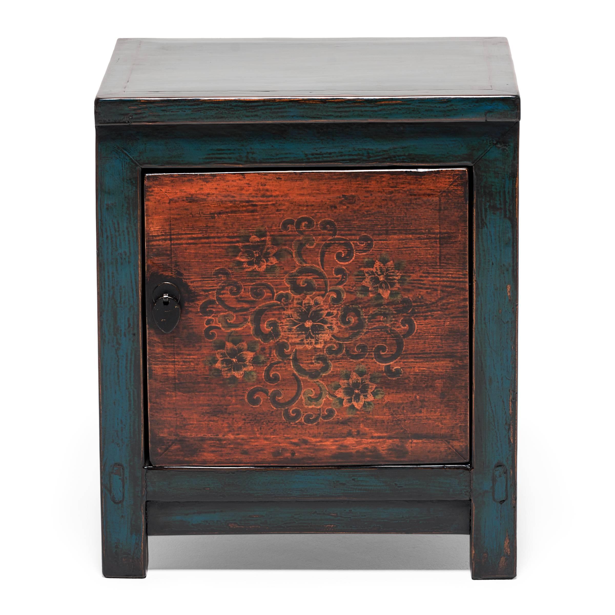 Made in Mongolia circa 1900, the original pine chest from which this pair was born was used for general household storage. The front panels are hand-painted with stylized chrysanthemum blossoms, the quintessential flower of autumn and a traditional