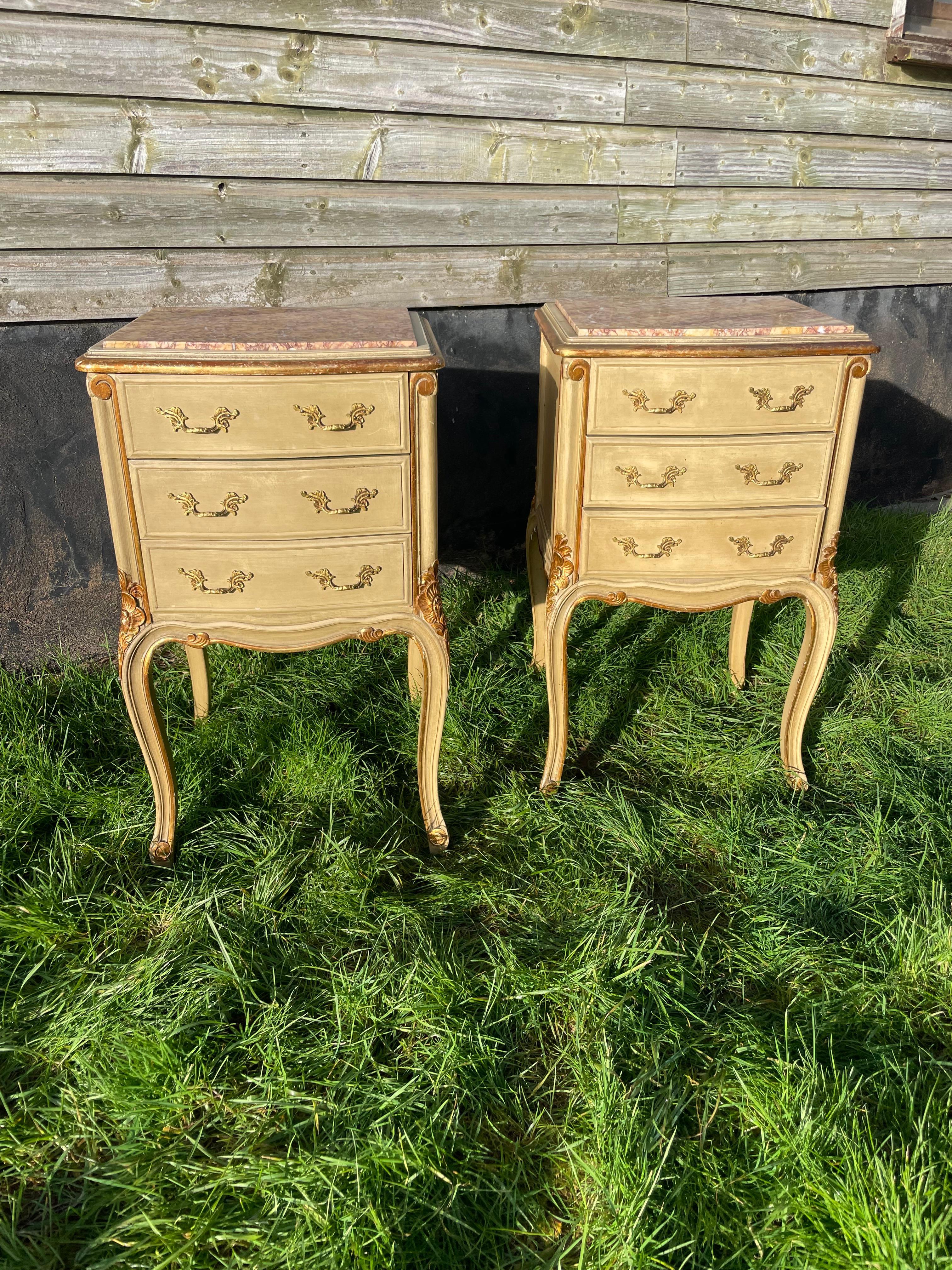 Great pair of Early 20th century painted and gilded bedside cabinets , with original marble tops and handles 

French circa 1920’s each cabinet having 3 drawers 

28.5 inches high 
17 inches wide
15 inches deep 