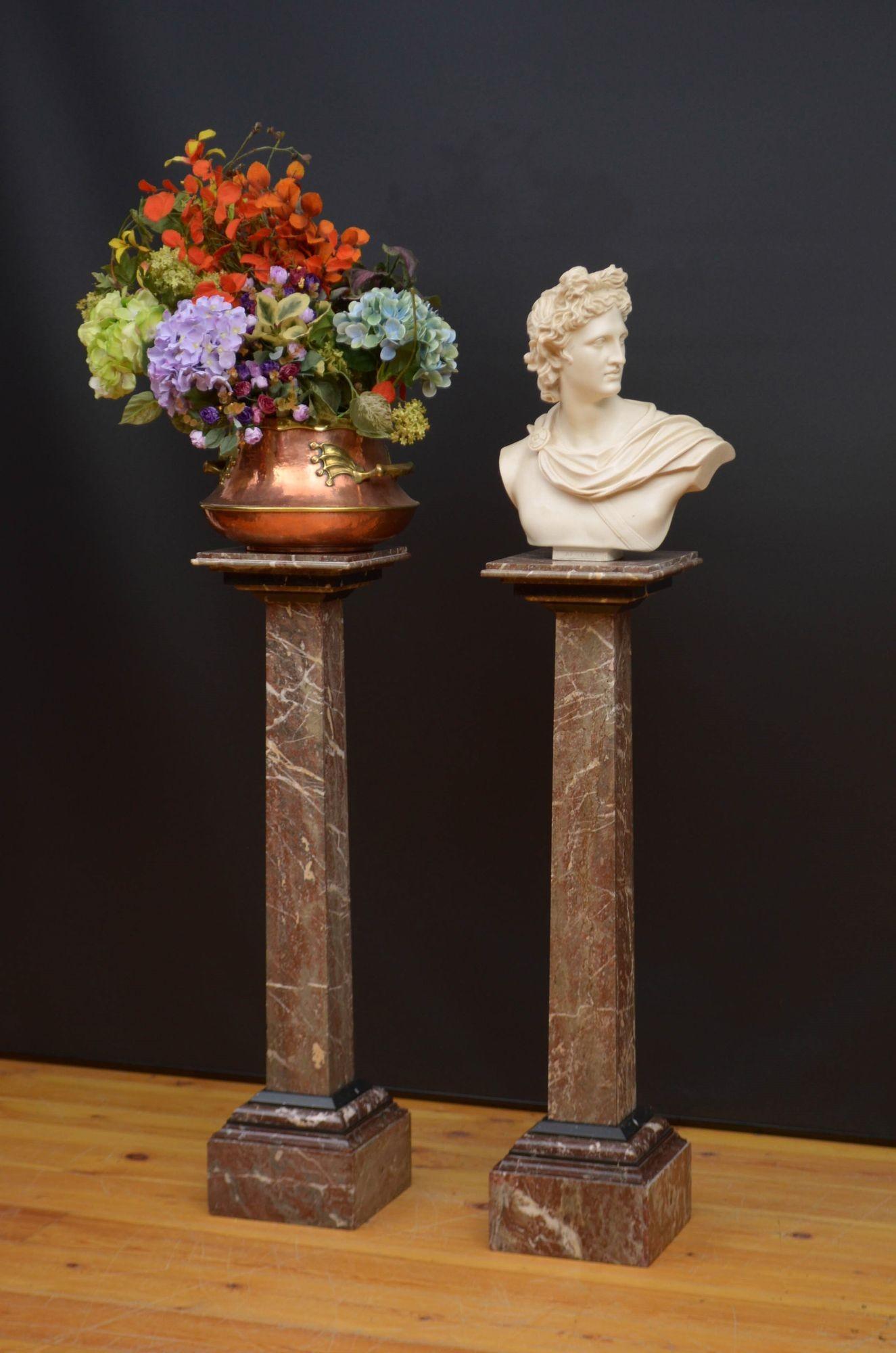 Sn5500 Stylish early XXth century rouge marble columns, each having square top for displaying flowers or sculptures above a stepped collar and tapering pedestal terminating in heavy square plinth base. This antique pair of columns is in home ready