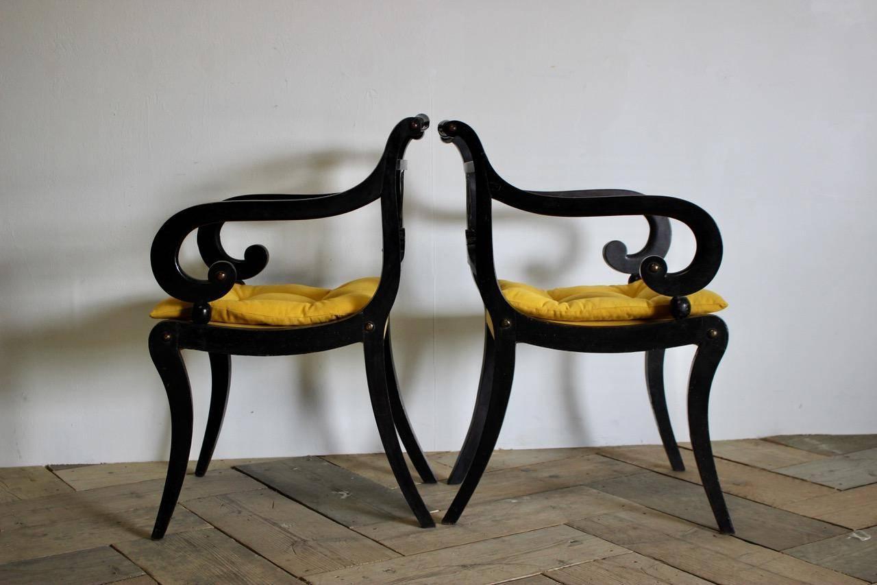 A fine pair of early 20th century armchairs in the English Regency taste, of great quality and retaining the original decoration, having been reupholstered by us in an antique hand dyed linen.