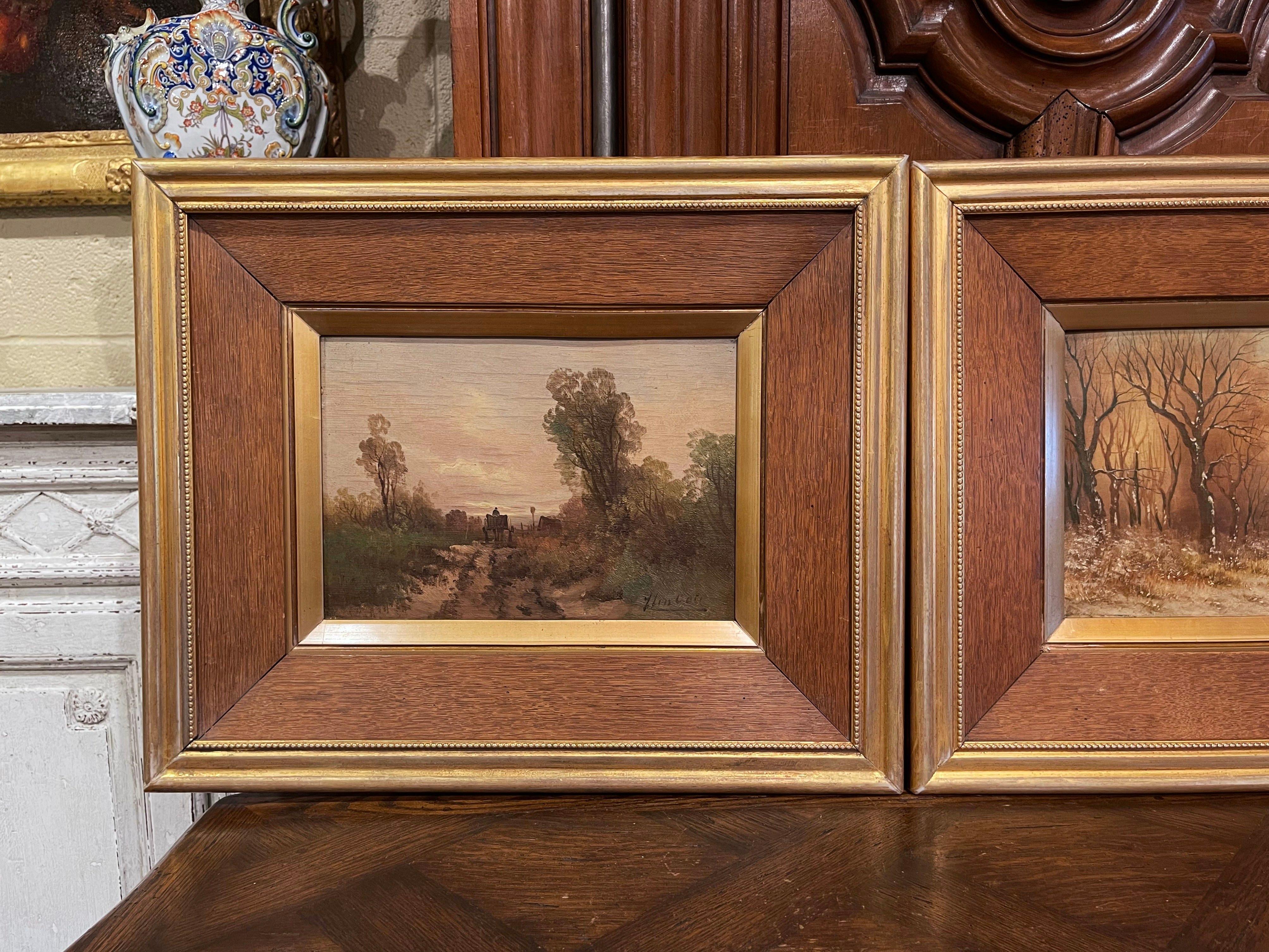 Decorate a kitchen wall or an office with this elegant pair of antique paintings; crafted in Holland, circa 1920, each artwork is set in the original carved oak and gilt frame; each painting depicts a pastoral countryside scene in the summer and