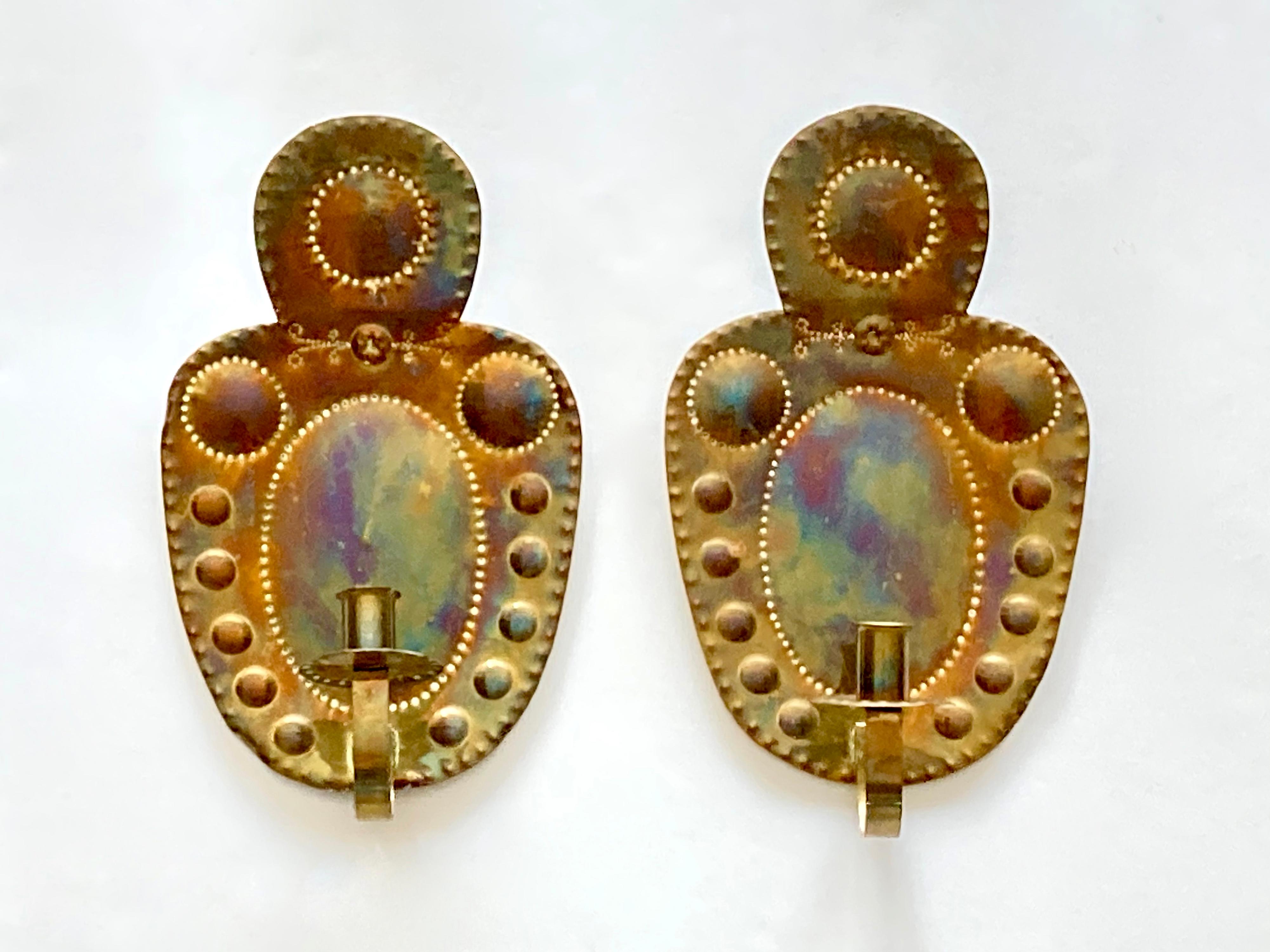 A pair of two authentic and decorative antique wall candle scones. Sourced and made in Sweden in the early 1900s. These wall scones are made of embossed/hammered brass and made for traditional candles (they are not wired). They are hand-made and