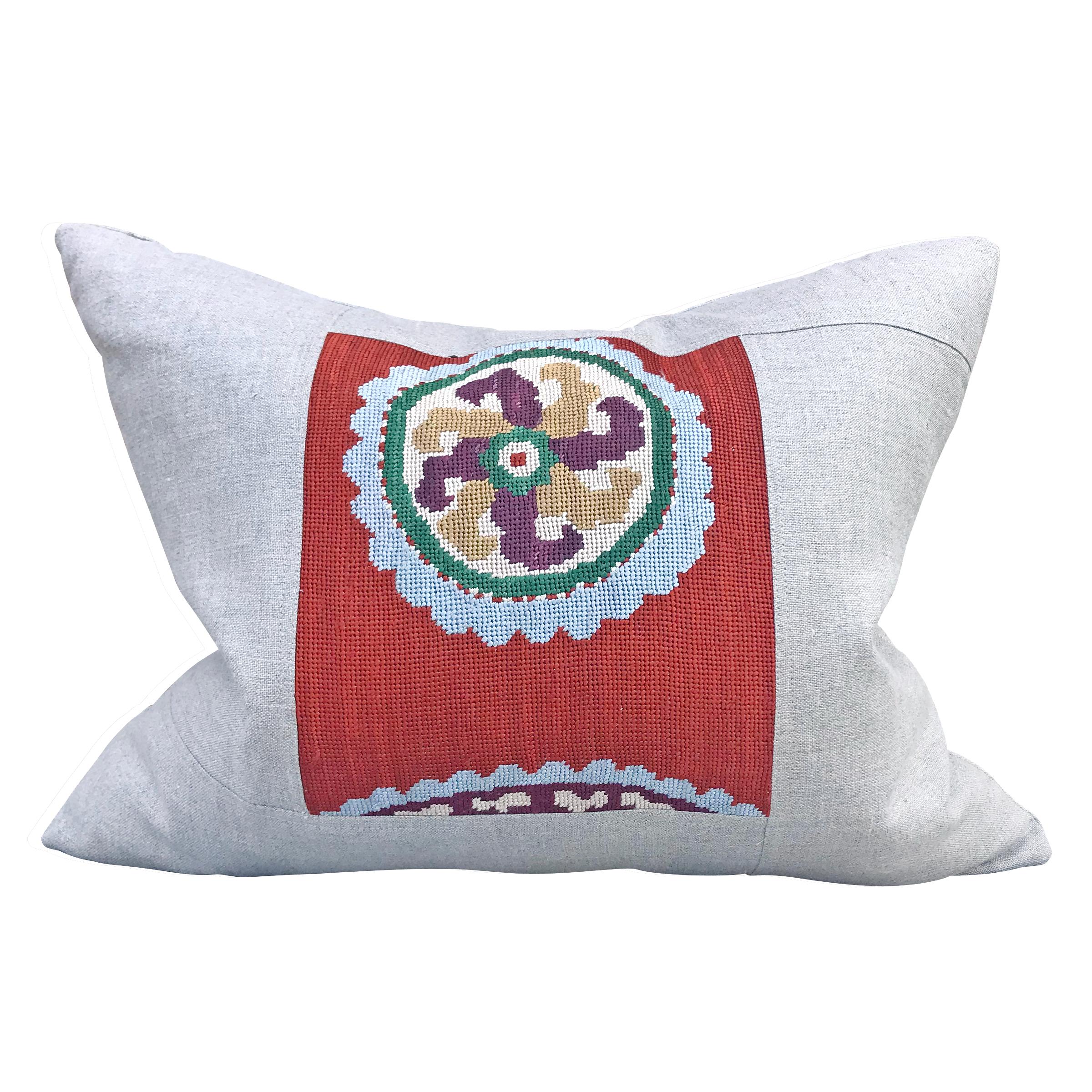 A pair of pillows made from early 20th century Uzbek folk embroidered panels with a lovely stylized floral pattern, framed and backed with linen, filled with down.