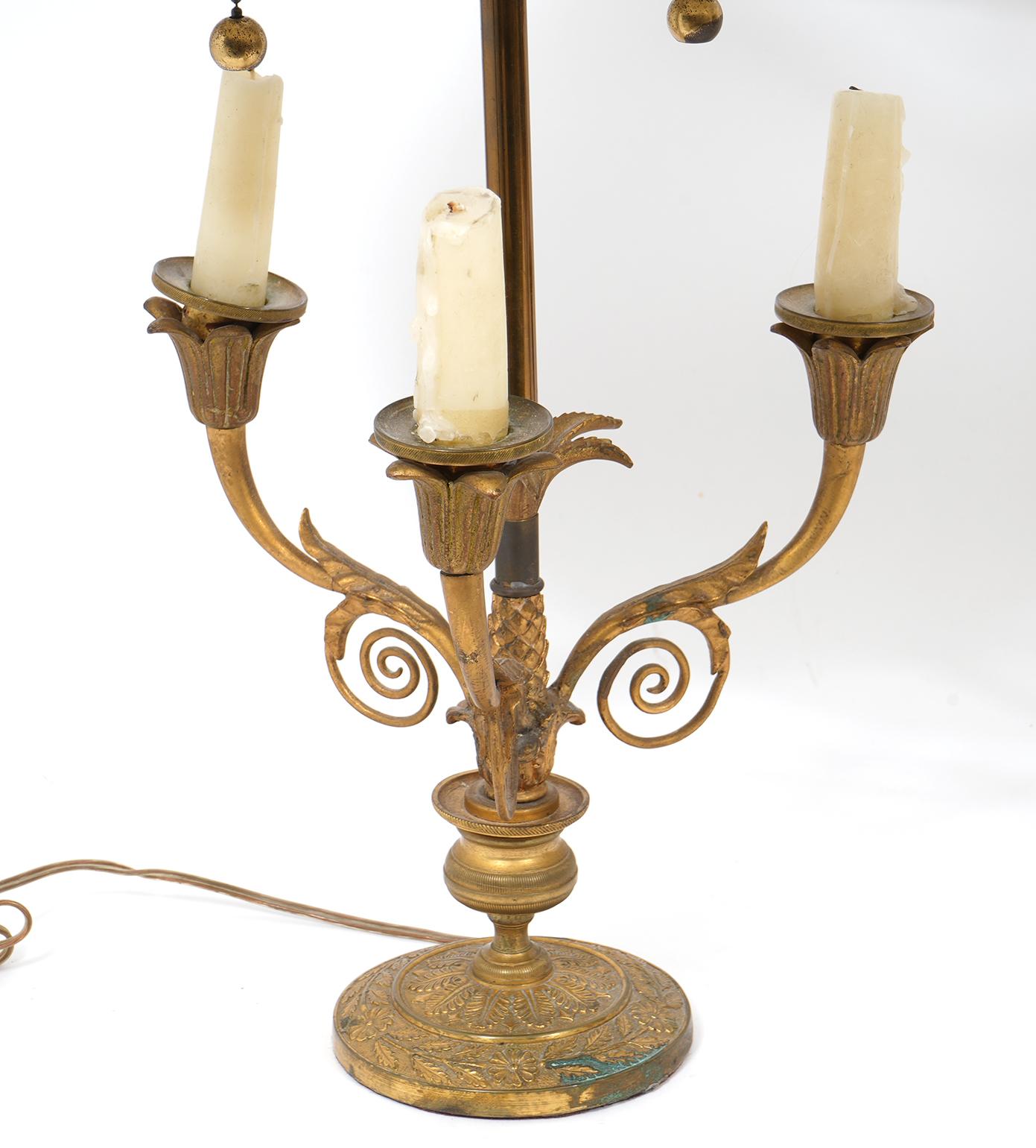 Pair of nicely detailed bronze lamps. French, early 20th century. Painted tole shades adjust up and down. Newly rewired.