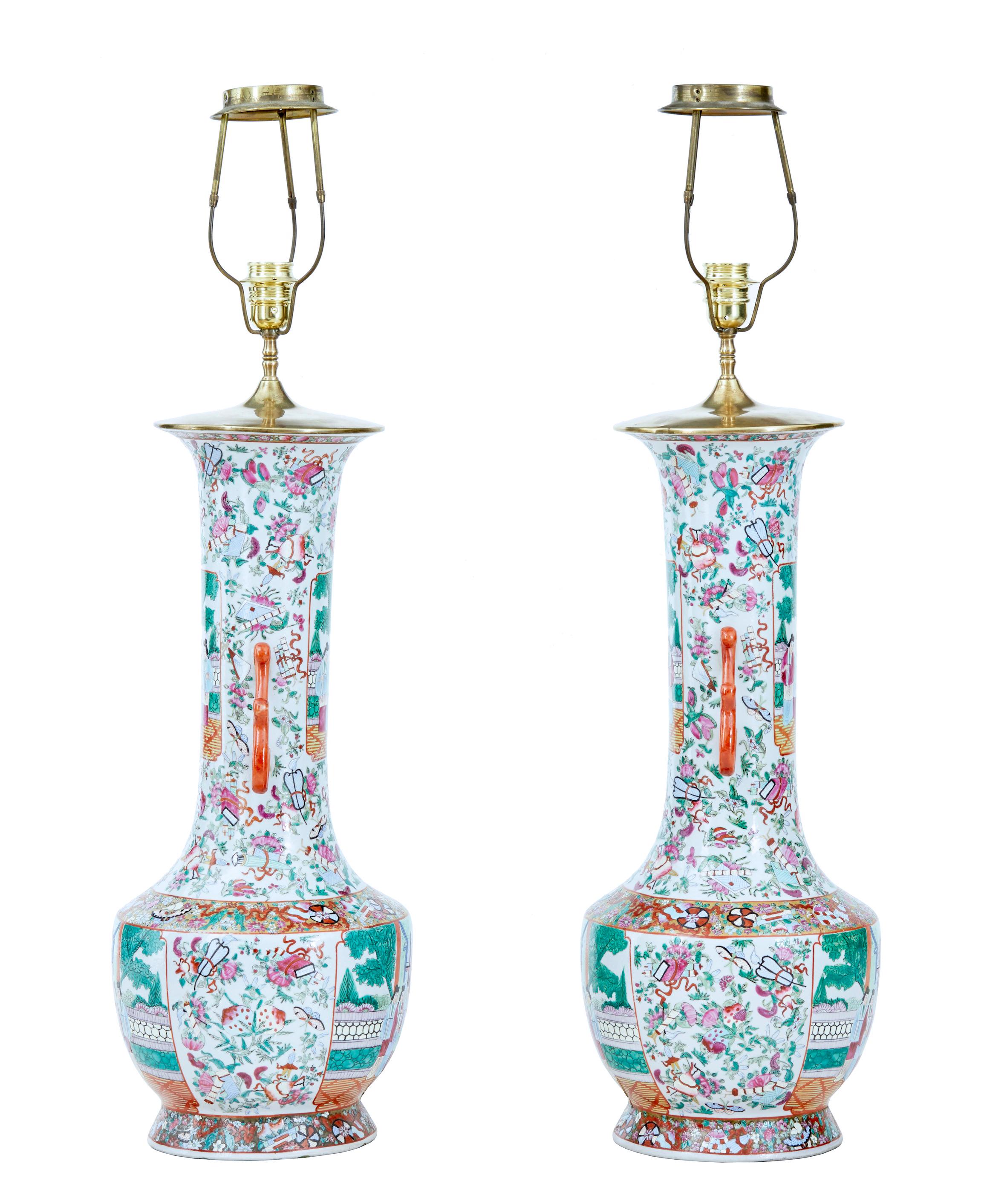 Pair of early 20th large Chinese Cantonese vase lamps, circa 1910.

Beautifully hand painted in green, pink and orange on a white background. These are a left and right pair and have always been a pair.

Later converted sympathetically into a