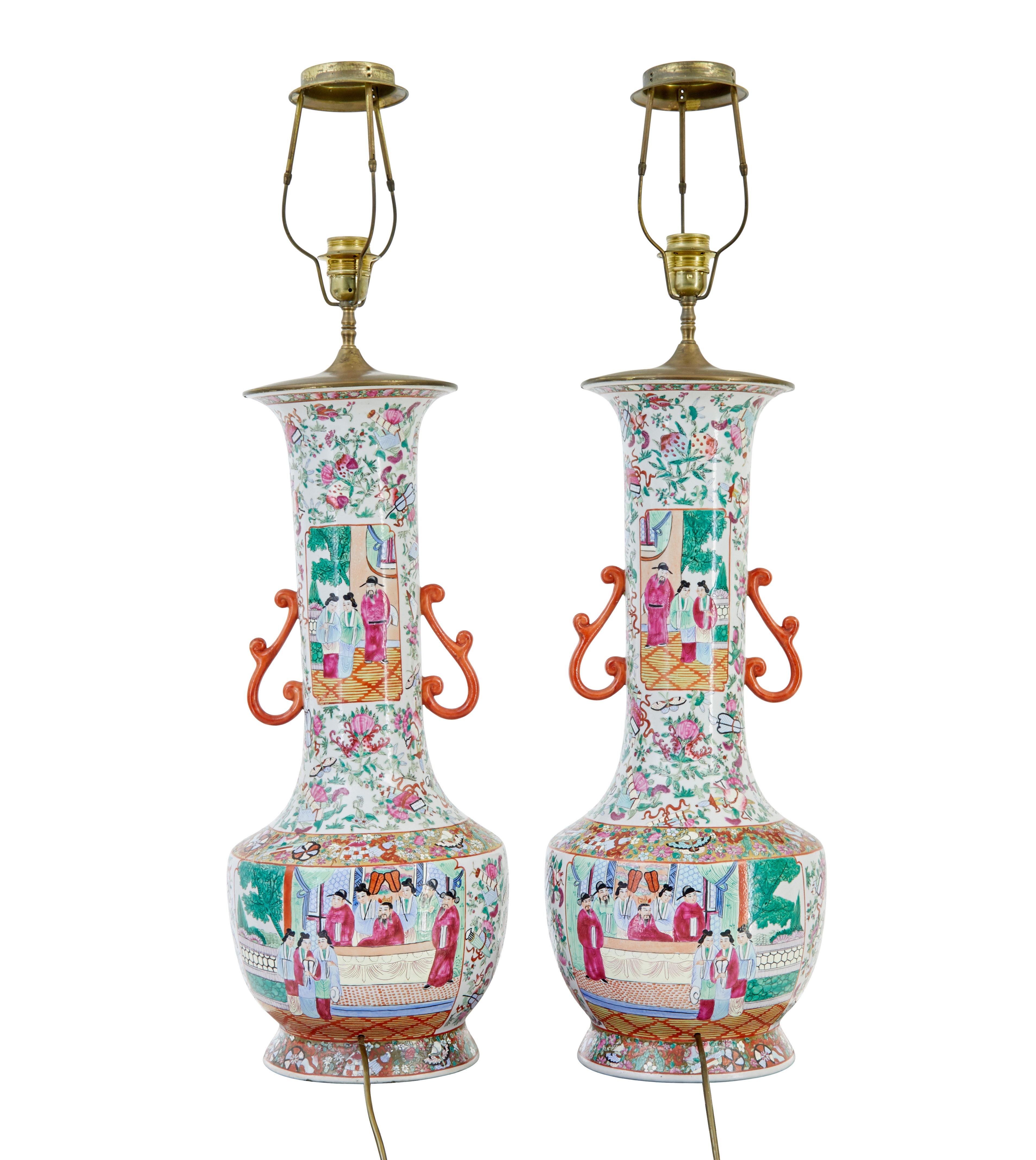 Pair of early 20th large Chinese Cantonese vase lamps circa 1910.

Beautifully hand painted in green, pink and orange on a white background. These are a left and right pair and have always been a pair.

Later converted sympathetically into a pair of