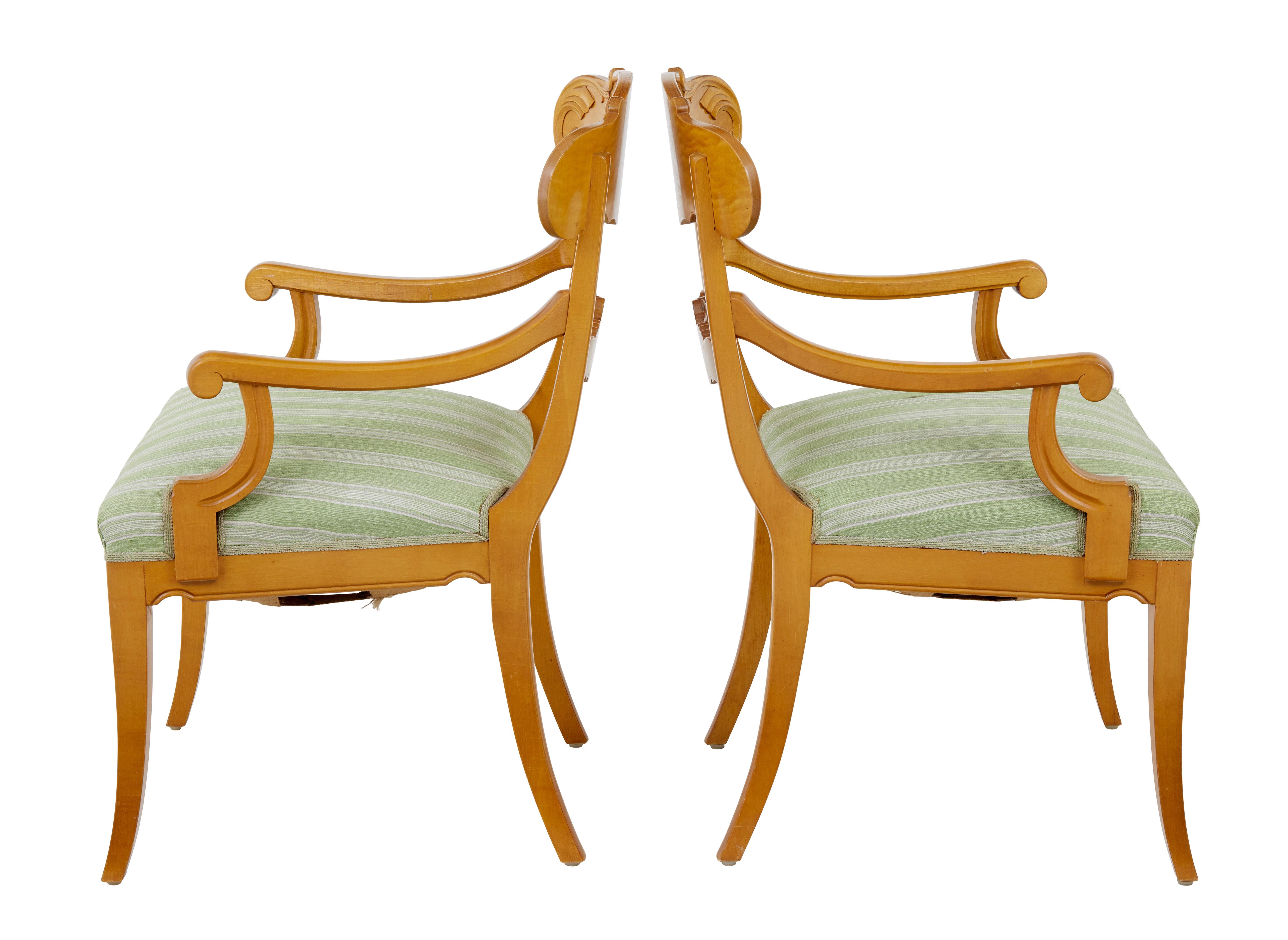 Pair of early 20th Swedish carved birch armchairs circa 1920.

Good quality pair of birch armchairs in the karl johan taste.

Shaped and carved back rest, flowing to the scrolling arms.  Standing on sabre legs.

Upholstery with some plucking and