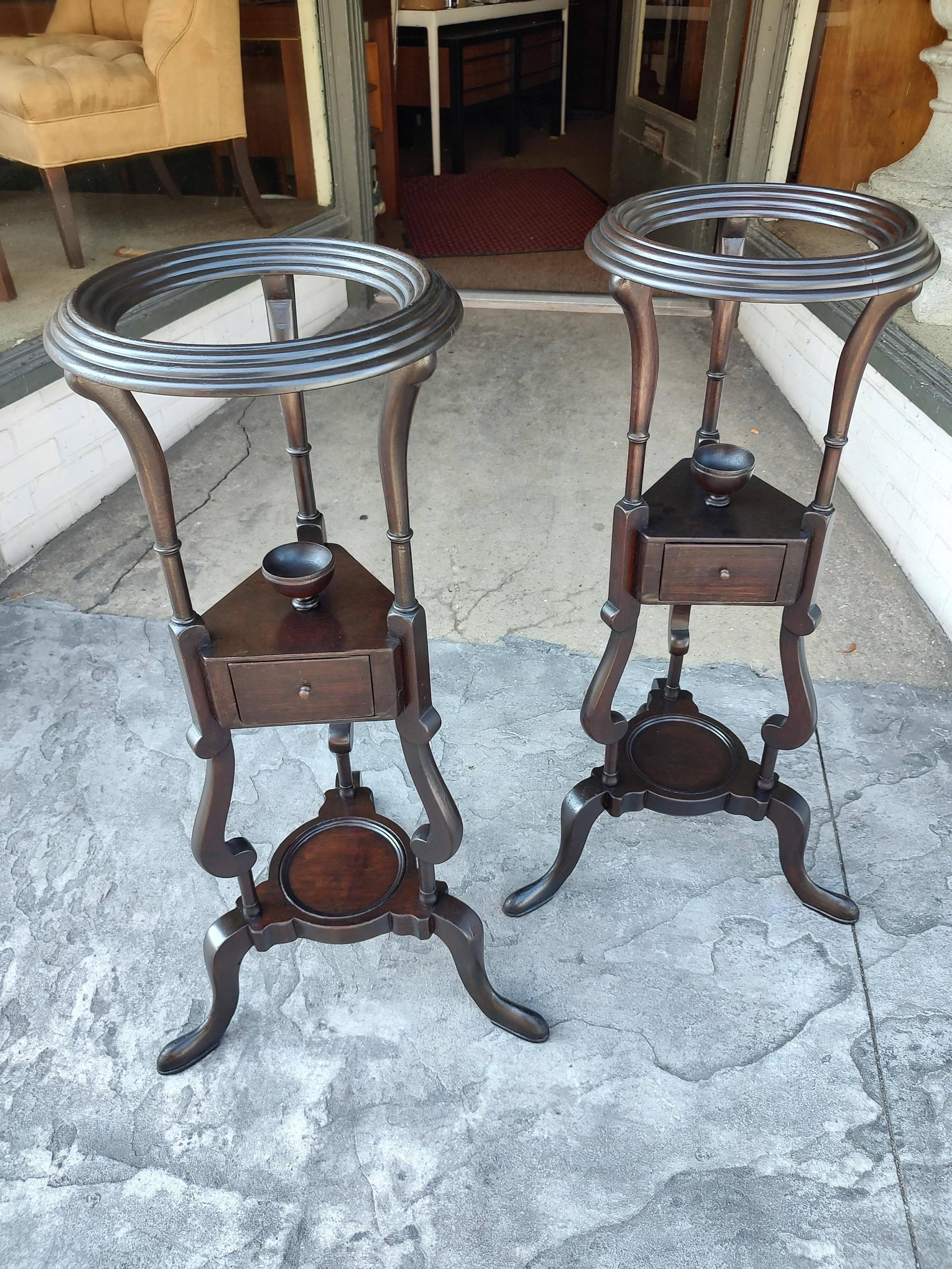Fabulous and elegant pair of mahogany Plant stands with each having a drawer and decorative urn. Hand crafted at the turn of the century in England, possibly earlier. Refinished and looking spectacular. Opening is almost 8.25.
Copper pot pics to