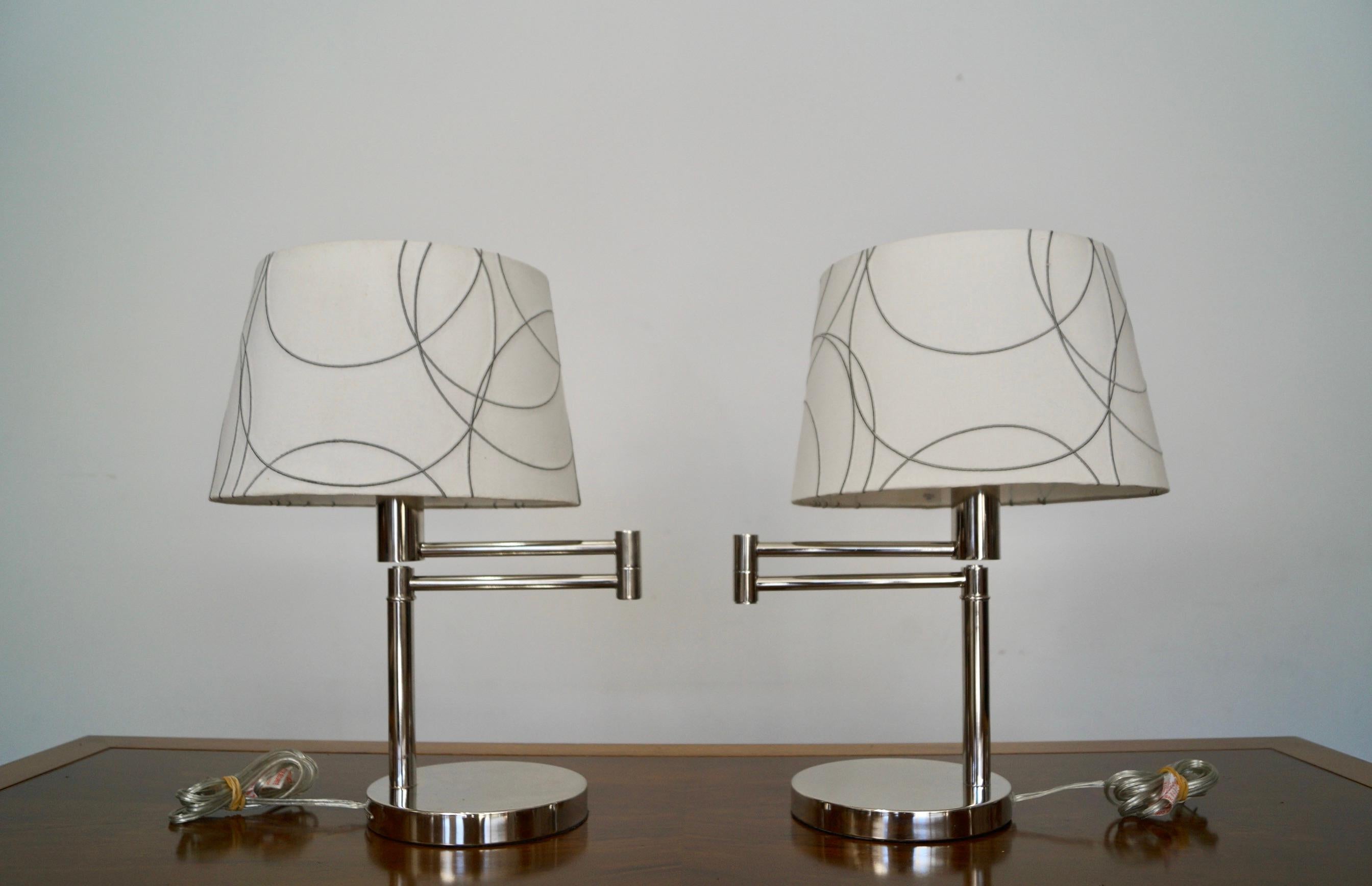Pair of vintage early 2000’s table lamps for sale. Manufactured by Ralph Lauren, and very well made. They are made of chrome, and are swing-arm lamps with the original noughties shade. The lamps are in excellent condition, as are the original post