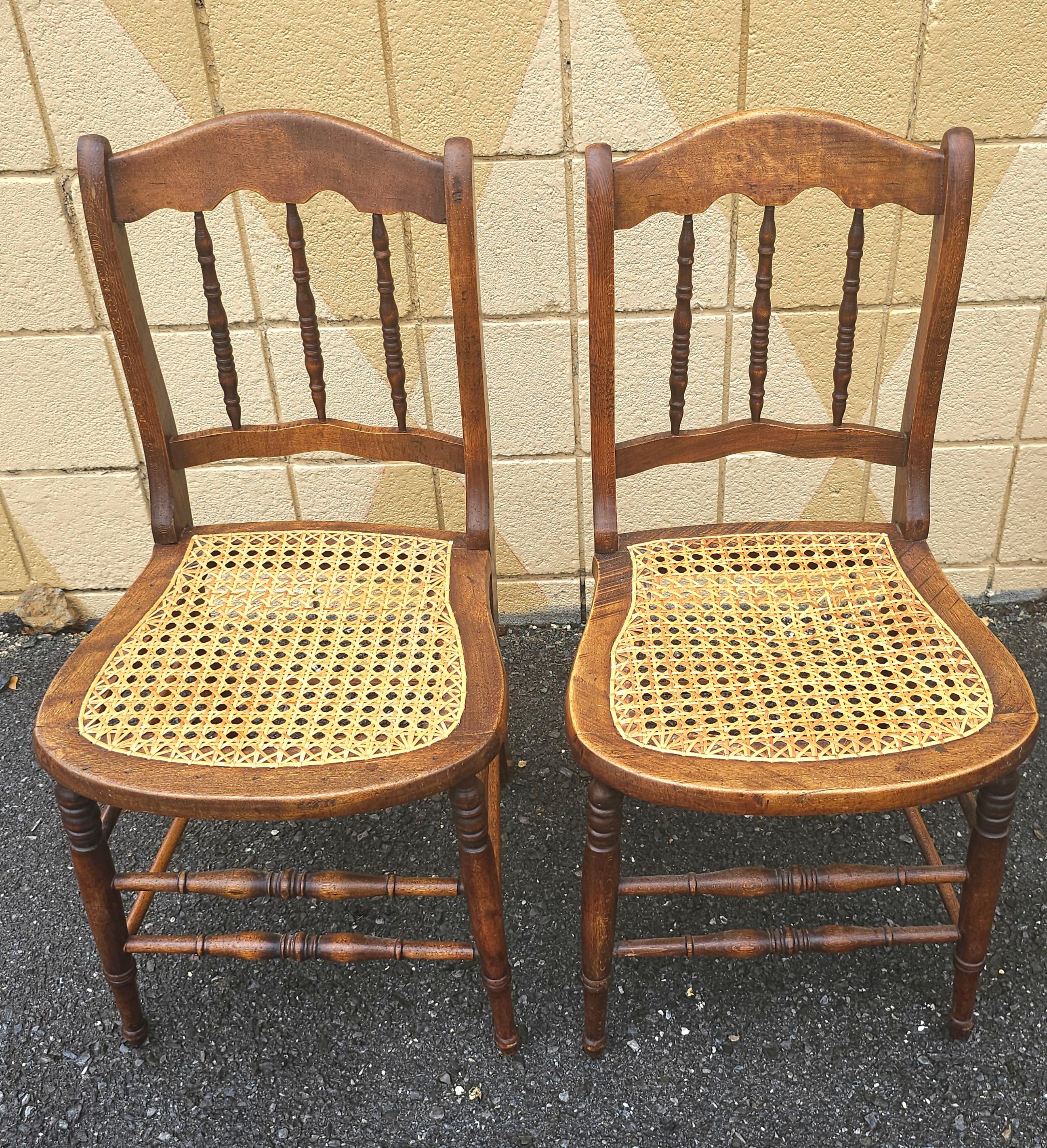 A Pair of Victorian Walnut and Cane Seat Spindle Back Side Chairs with newer caning.
Measures 16.5