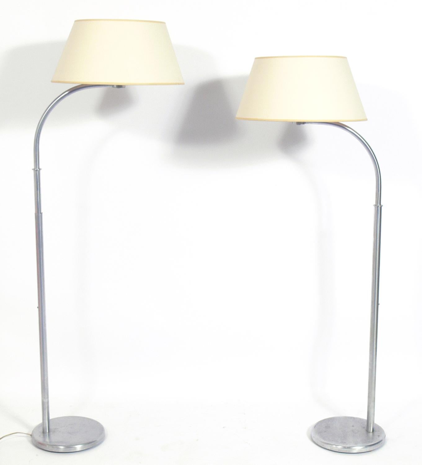 Pair of early Art Deco floor lamps, designed by Walter Von Nessen for Nessen Studios, American, circa 1940s. They slide up and down for an adjustable height. They have been rewired and are ready to use.