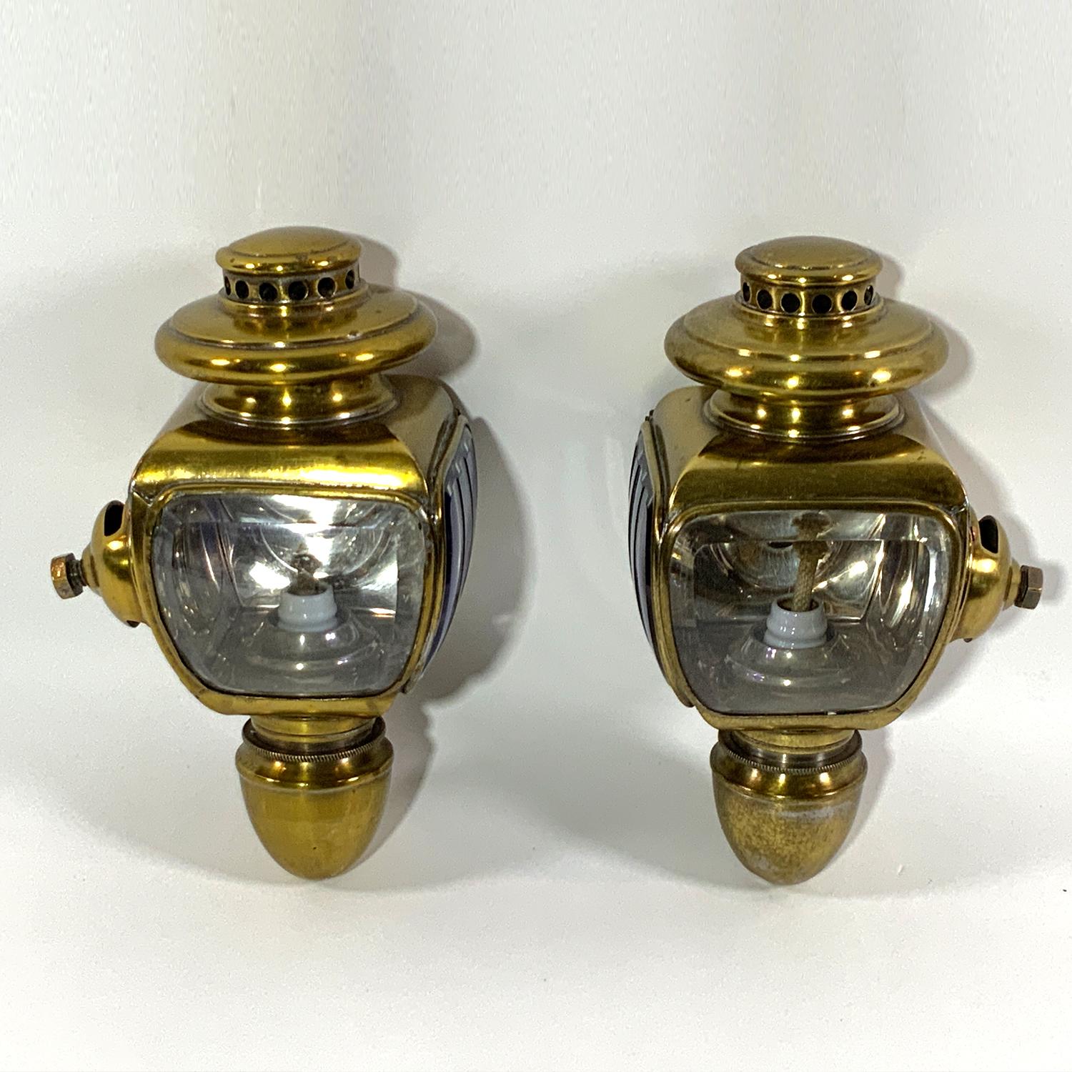 Early twentieth century cobalt glass carriage lanterns. Highly polished brasses. Quality pair. Circa 1910. French made. Scarce cobalt cut to clear beveled glass and ruby jewel.