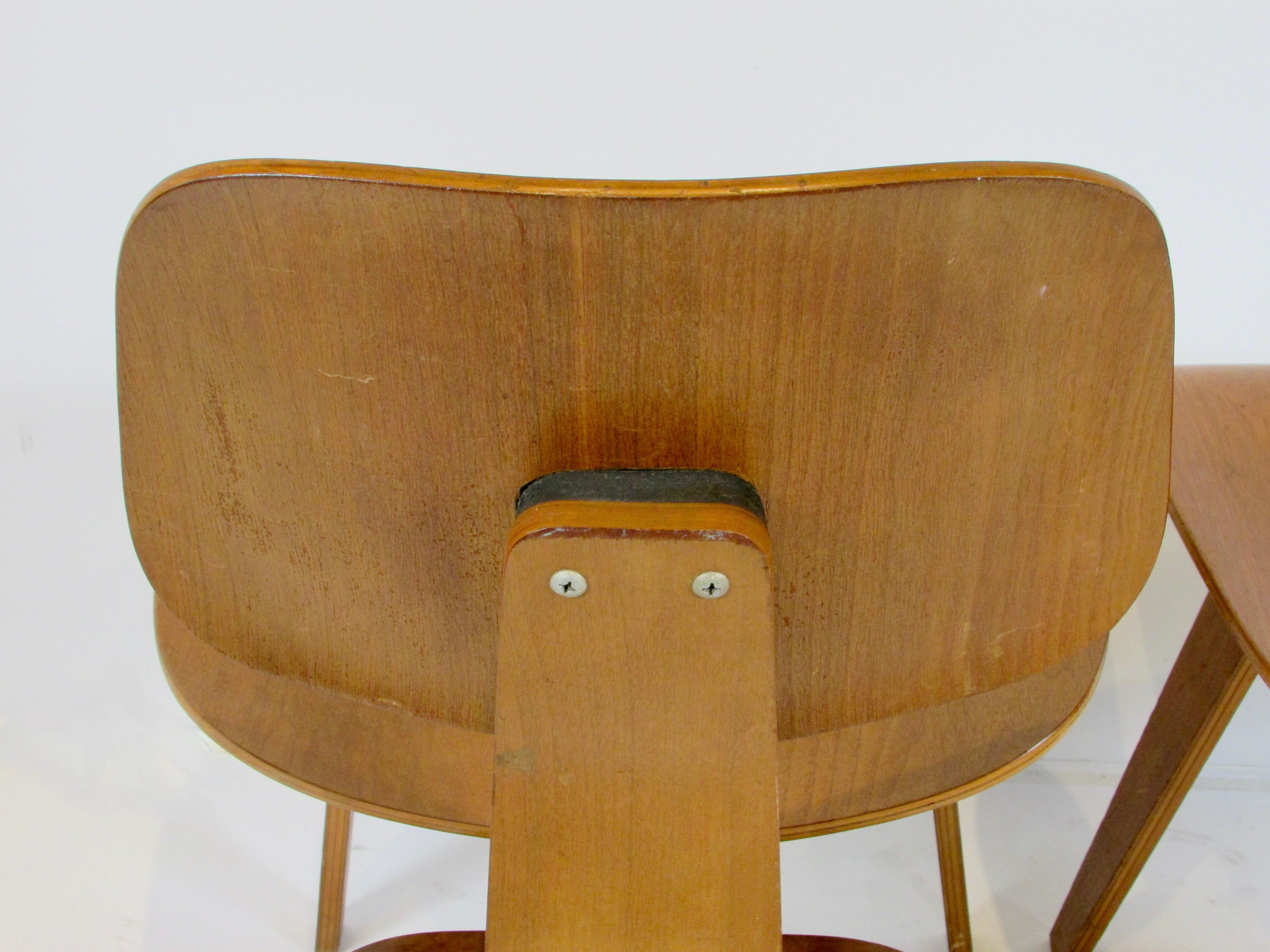 Pair of early Eames Evans Herman Miller walnut DCW chairs with labels 5