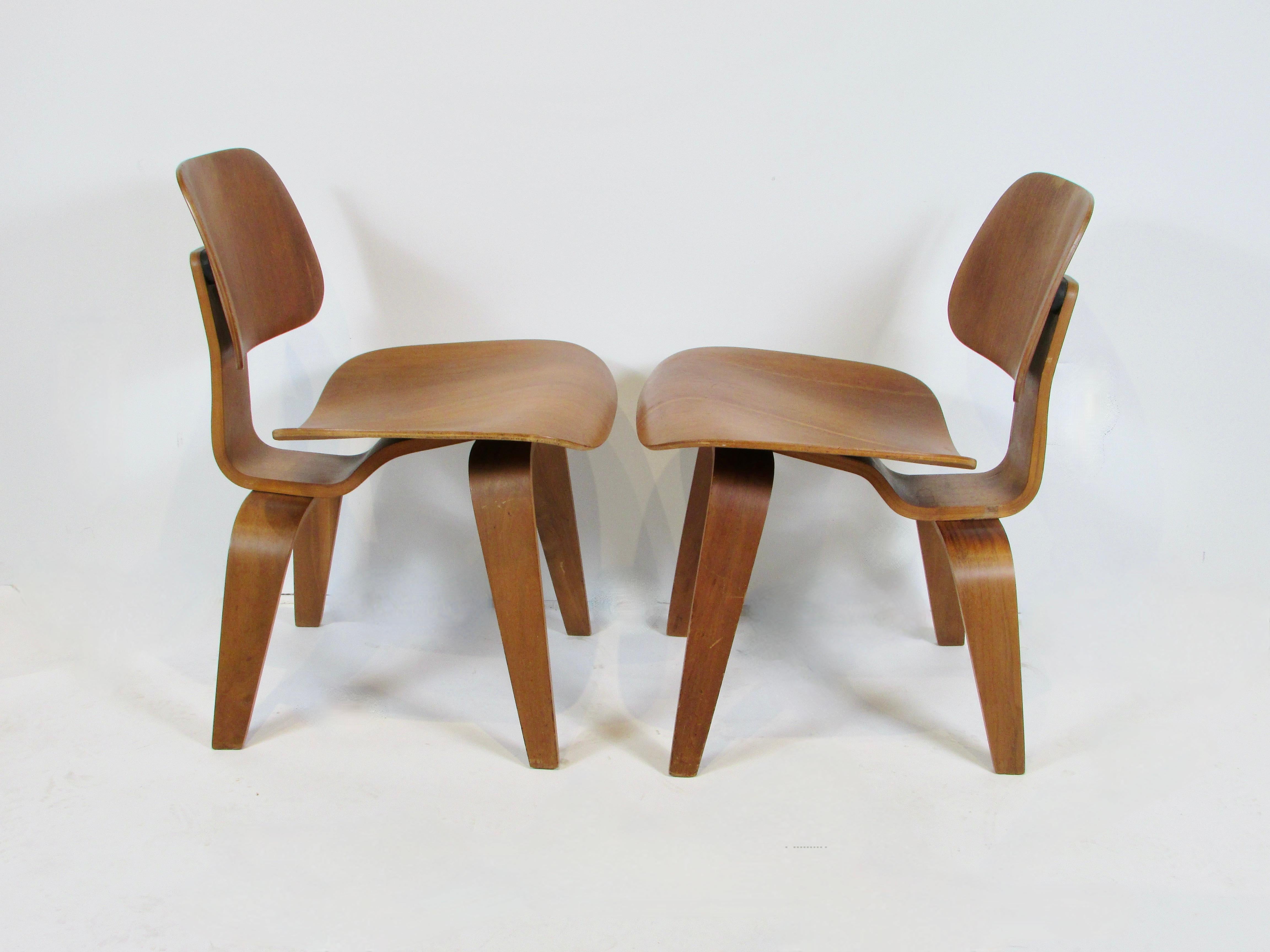 Hand-Crafted Pair of early Eames Evans Herman Miller walnut DCW chairs with labels For Sale