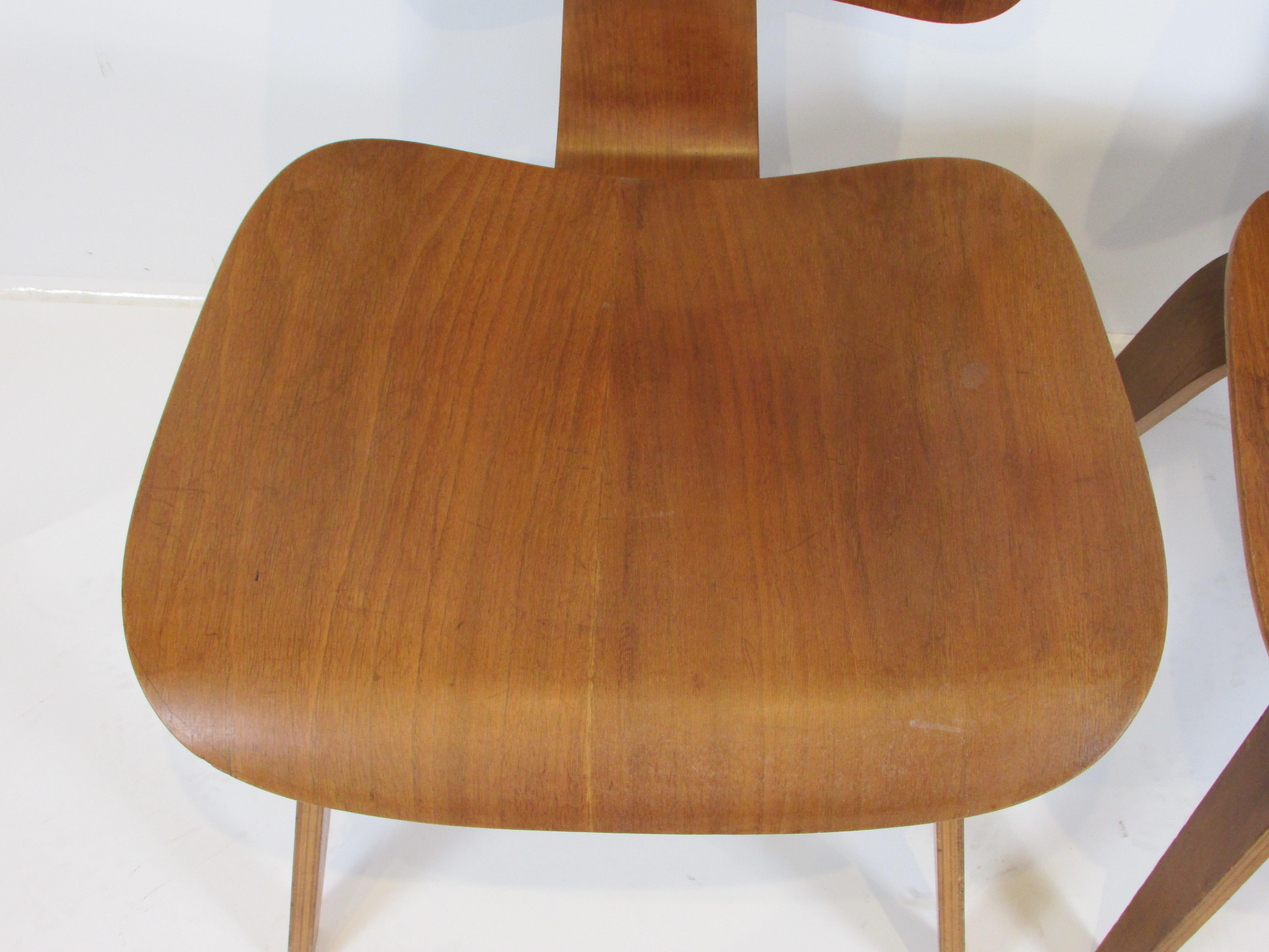 20th Century Pair of early Eames Evans Herman Miller walnut DCW chairs with labels