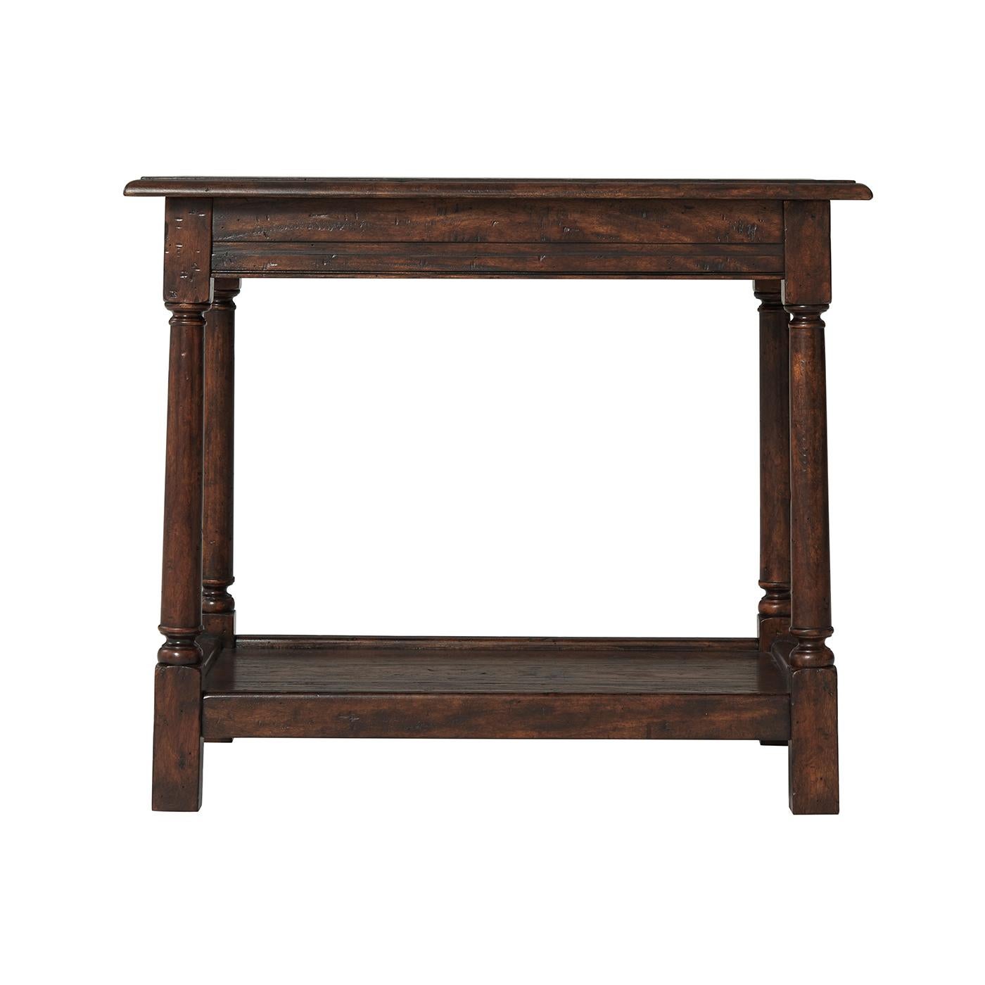 Early English mahogany and reclaimed oak occasional 'Joynt' table, the planked rectangular top with a molded edge, above a paneled frieze with gently splayed turned legs terminating in block feet joined by a planked tray under tier. Inspired by a