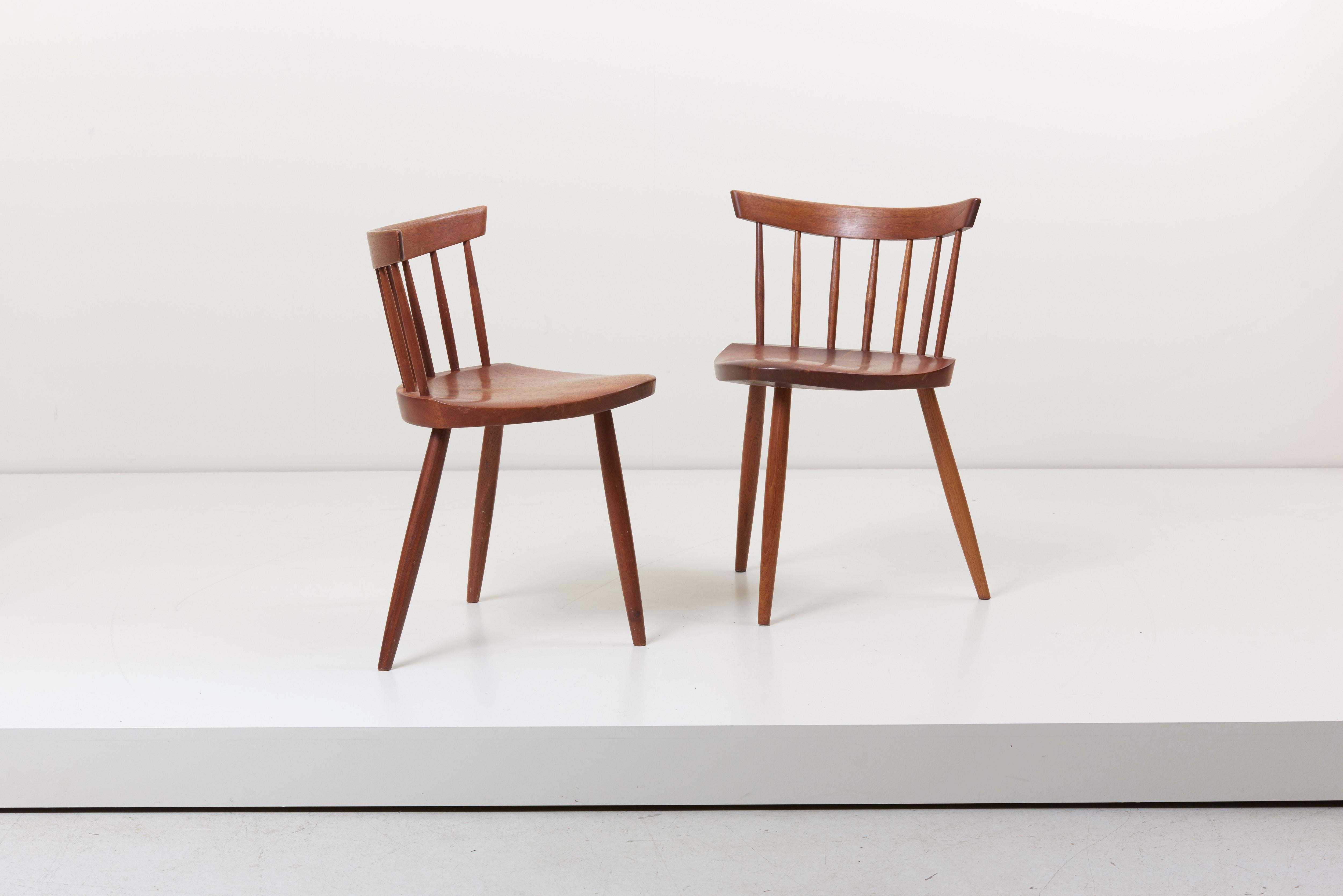 Vintage version of a pair of the Mira Chair by George Nakashima. The chairs are in walnut.
One bottom of the seat still shows lines and is marked with Showroom. Here is a statement from Mira Nakashima about this chair: All I can say for certain is