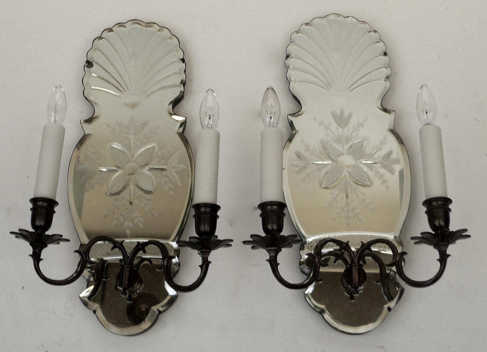 These handsome early Georgian style sconces feature wheel cut mirrored backs, with shell and snowflake motifs.