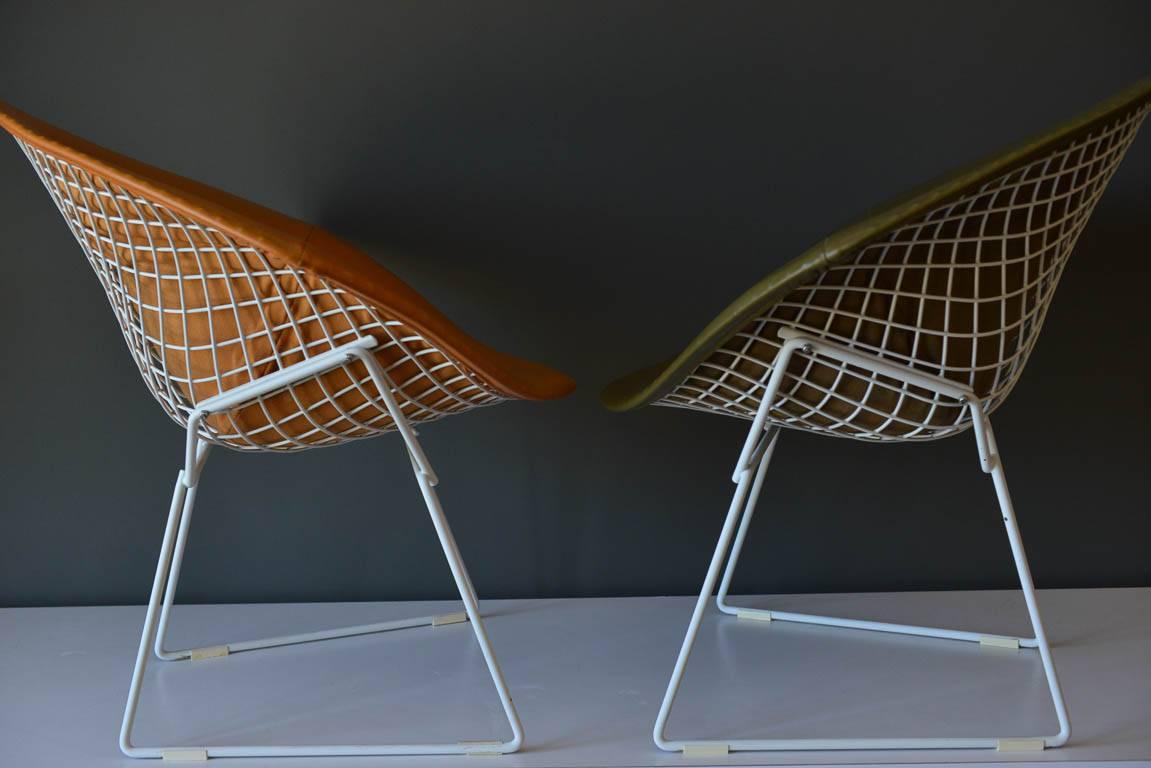 Pair of early Harry Bertoia for Knoll diamond chairs with original leather covers. Pristine vintage condition, each chair bears the 320 Park Ave. Knoll label. Leather is soft and supple with no cracks or breaks and the metal frame is intact with no