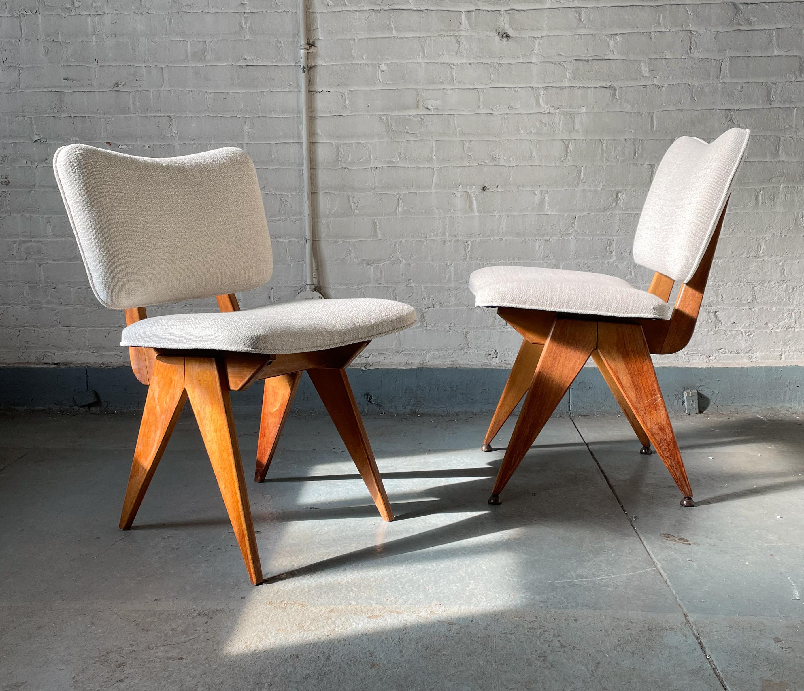 Rare pair of dining or side chairs in birch with compass-shaped legs designed by Jens Risom and produced by his fledgling eponymous company in 1947. Part of an innovative design series previewed in Interiors Magazine in March of 1947 and lauded for