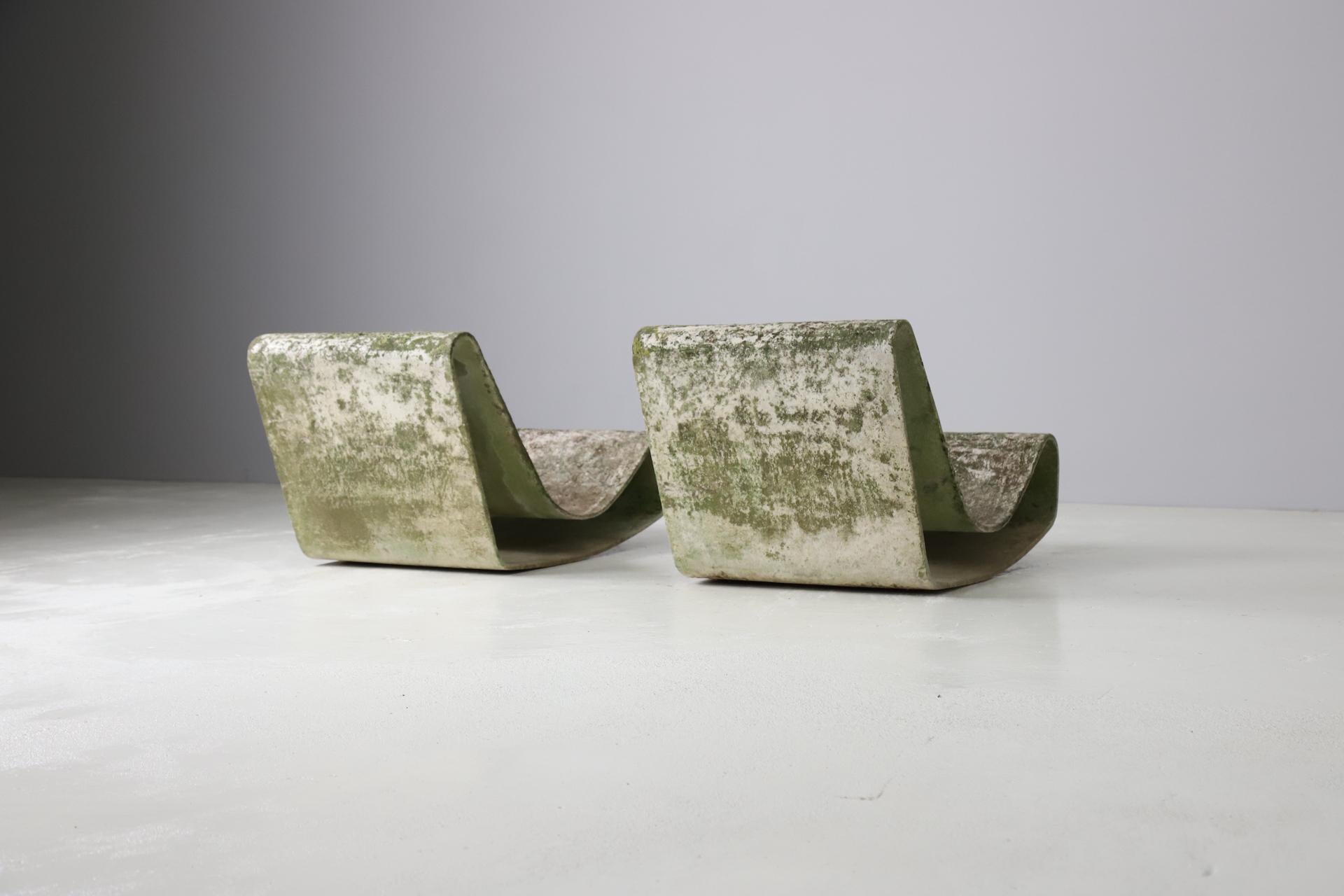 Very decorative pair of 'loop' chairs designed by Willy Guhl, 1954 Switzerland. These iconic loop garden chairs are one of the early productions, made in Switzerland. Made out of a continues sheet of reinforced concrete. Over the year the chairs
