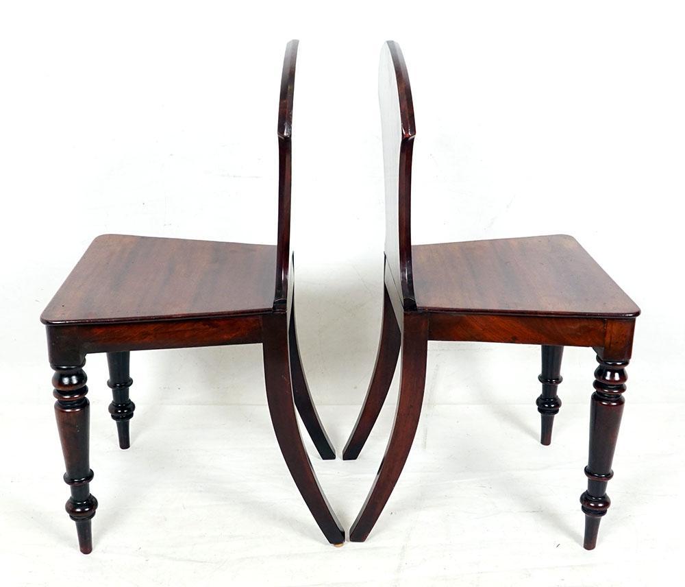Pair of early victorian English mahogany hall chairs.