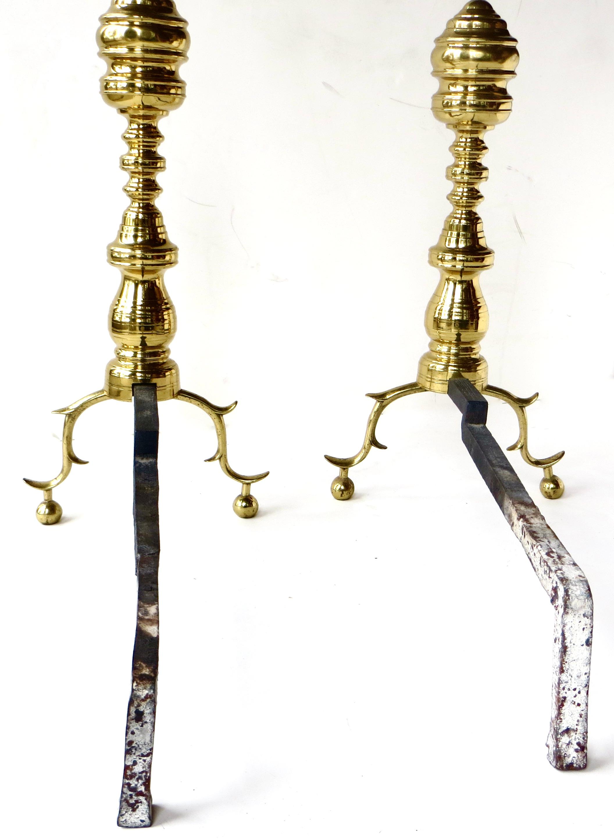Lovely original surface to these pair of classical Victorian solid brass andirons, with bold vertical turned and bulbous design to the post; connected below to horizontal iron log supports (billet bar). A vertical hand forged threaded rod goes up