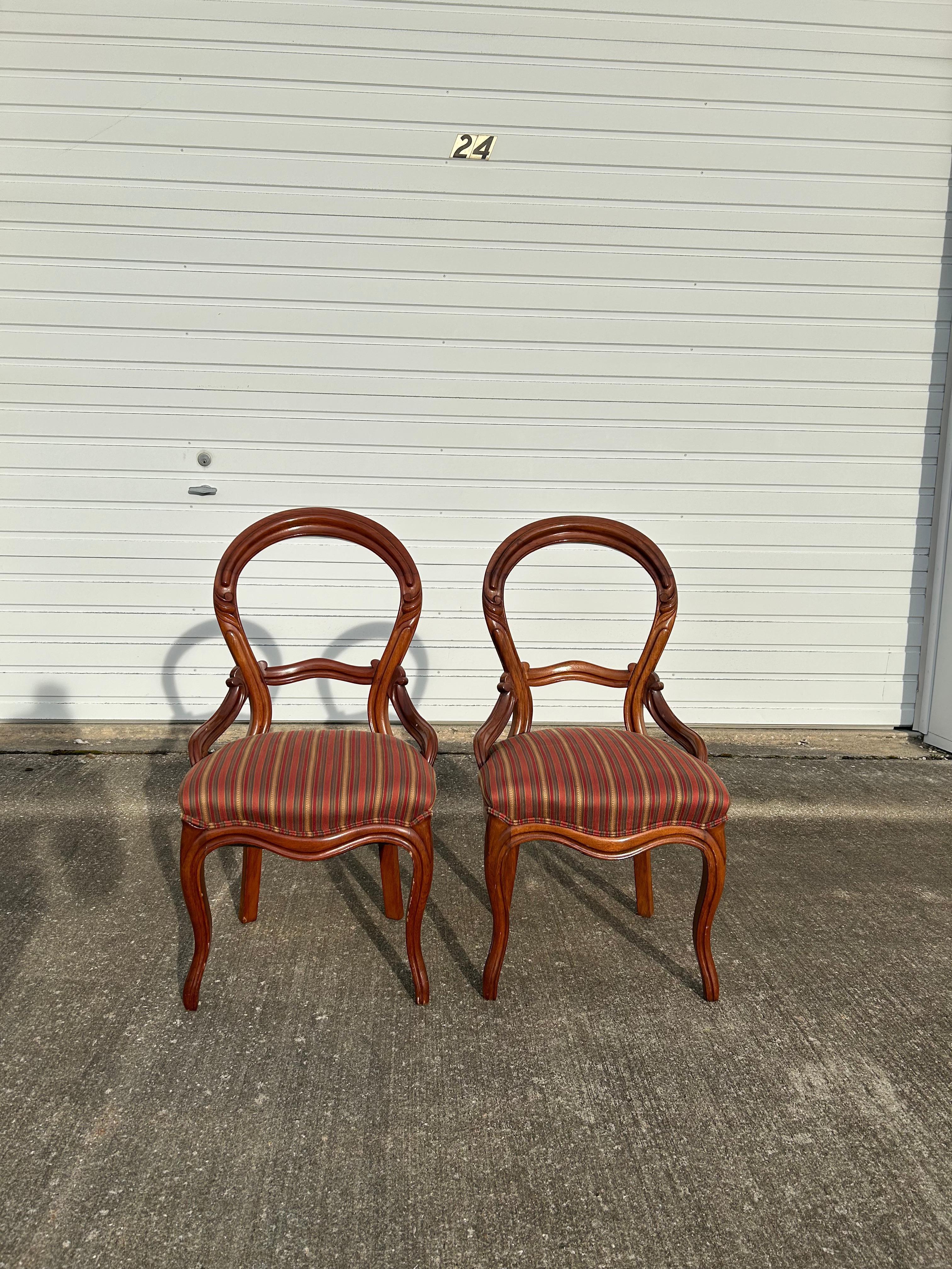 Pair of early Victorian side chairs in the style of John Henry Belter. These chairs are very unique and hold a pretty nice fabric, it does not seem like there are any stains or rips. The wood does need to be touched up due to its age, see pictures.
