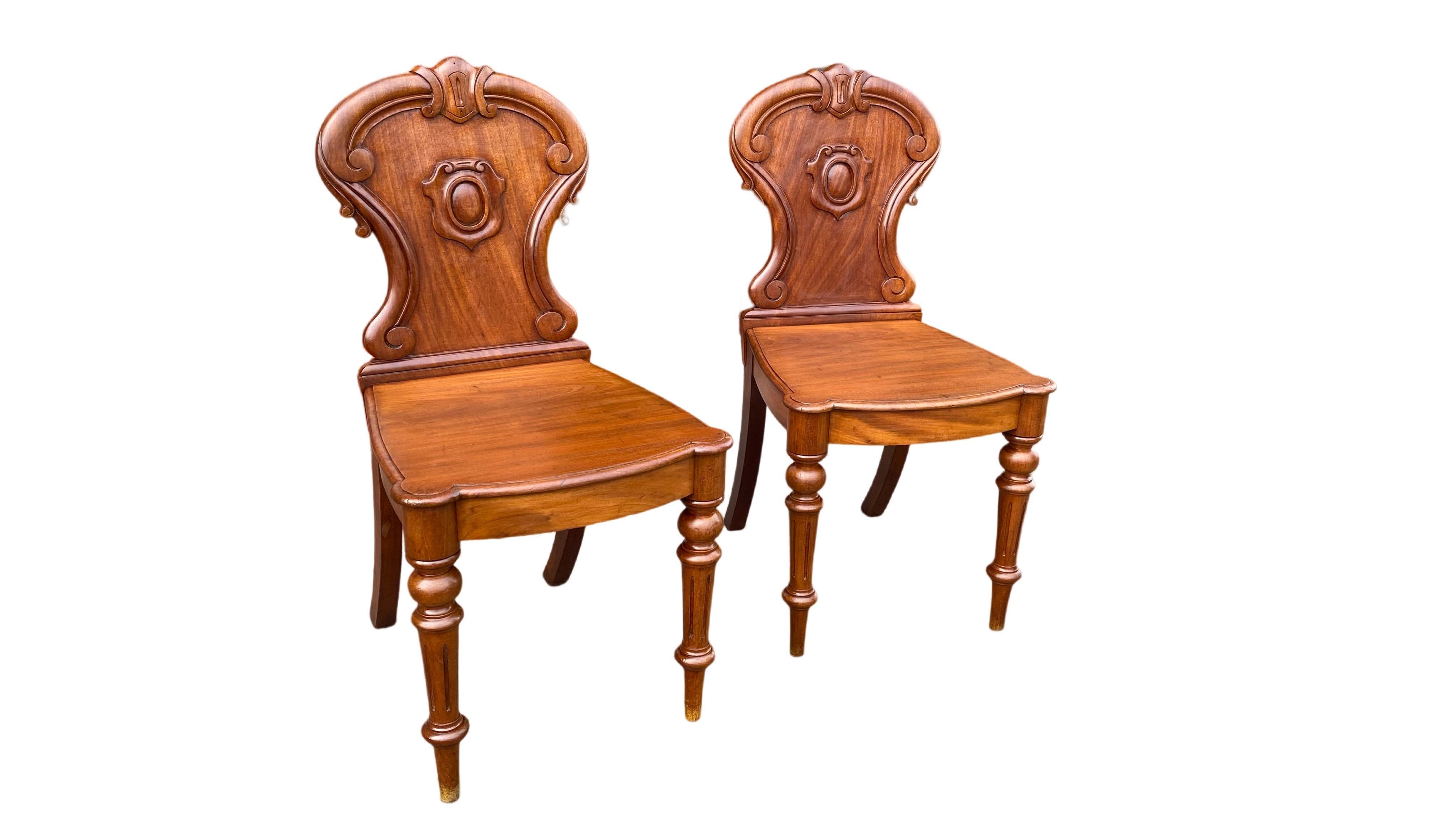 Carved Pair of Early Victorian Mahogany Hall Chairs For Sale