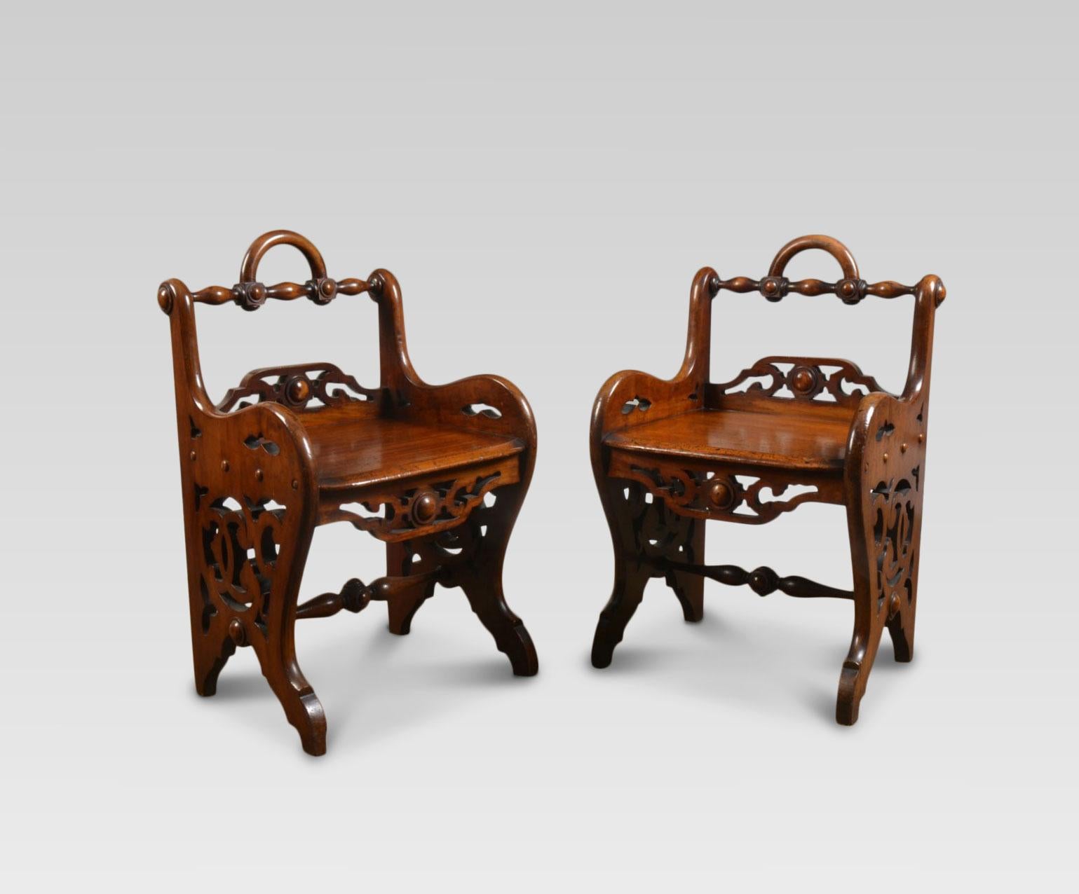 Pair of early Victorian mahogany hall chairs in the manner of Richard Bridgens. Each with a turned top rail above a pierced quatrefoil and scrolling foliated seat rail.

Dimensions:

Height 30.5 inches, height to seat 16 inches.

Width 18.5