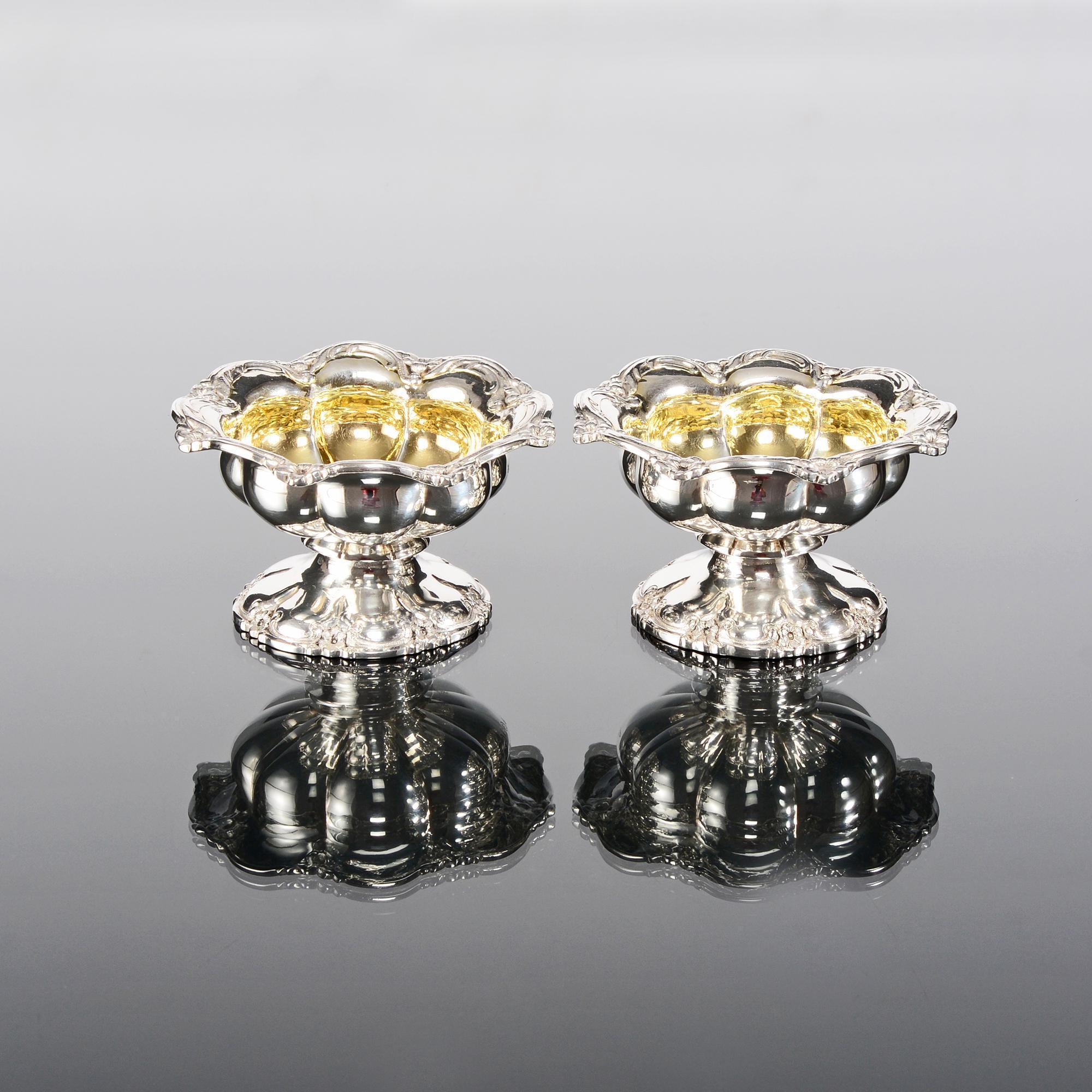 Pair of early Victorian antique silver salt cellars with circular melon fluted bodies, spreading circular bases and decorated with scroll and flowerhead borders. The interiors are beautifully gilded.

Additional information:
Weight 10 troy oz