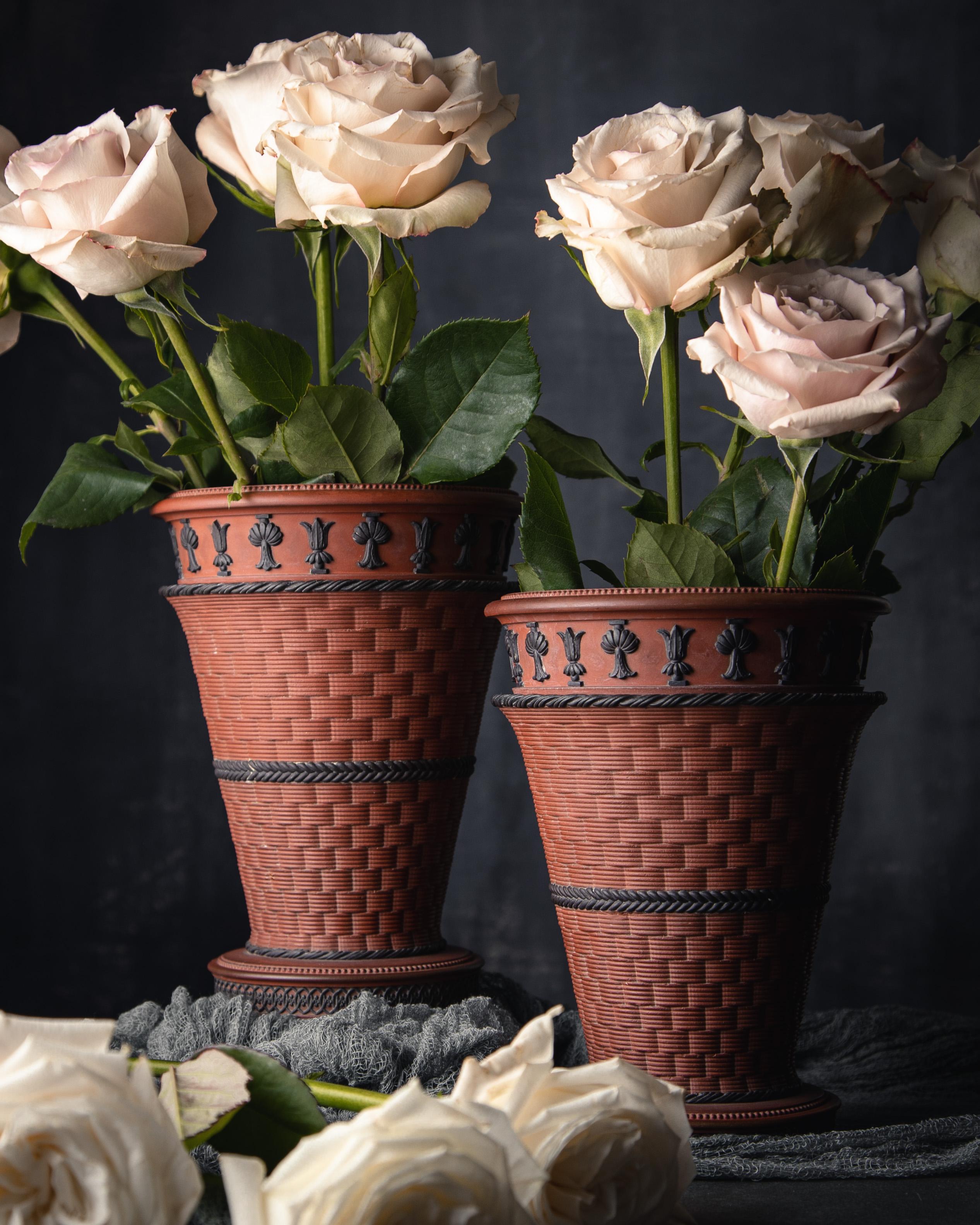 A pair of rosso antico jardinières made by Wedgwood, ca. 1810. This pair of jardinieres has a beautiful basketweave pattern accentuated by black basalt details in the Egyptian Revival style.

Developed by Josiah Wedgwood in the 1760s, rosso antico