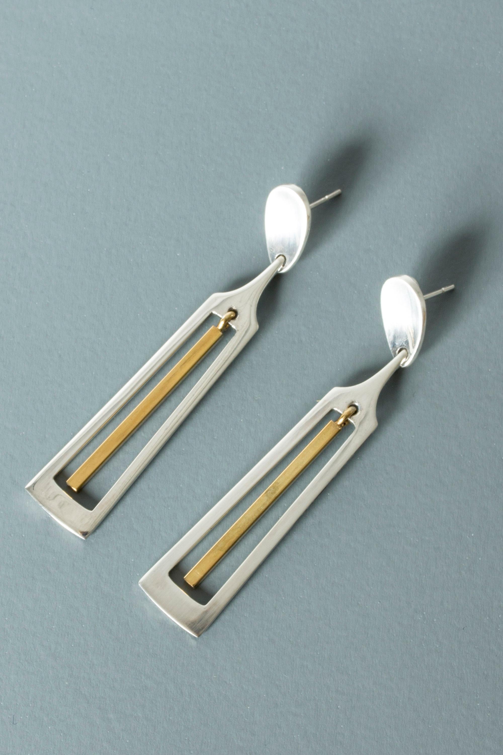 Pair of amazing, oversized earrings by Bent Gabrielsen Pedersen. Made from silver with a gilded pendant in the cutout middle. Strikingly cool design.